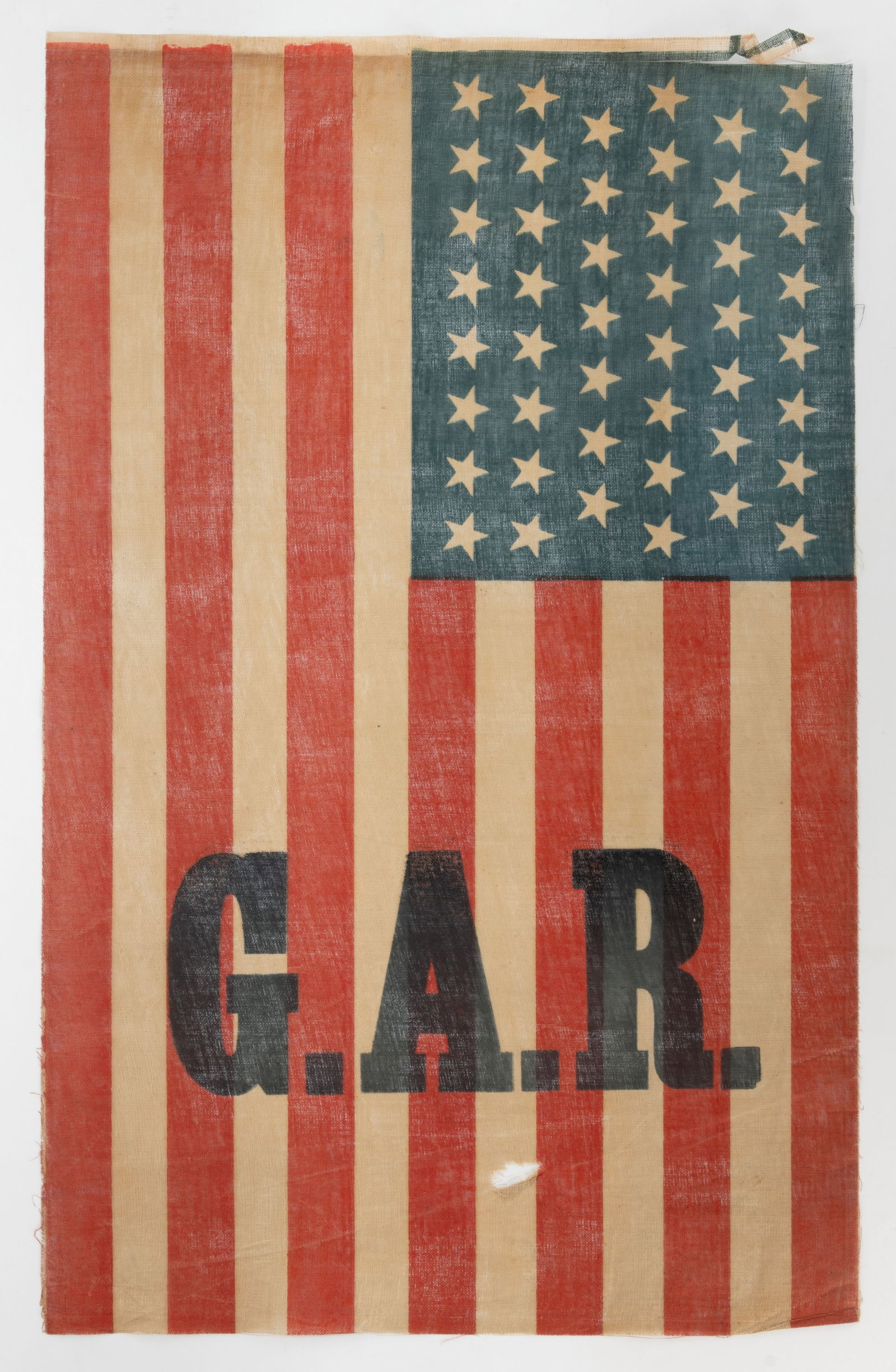 46-STAR GRAND ARMY OF THE REPUBLIC (GAR) PRINTED CIVIL WAR REUNION FLAG: 46-STAR GRAND ARMY OF THE REPUBLIC (GAR) PRINTED CIVIL WAR REUNION FLAG, glazed muslin, the canton exhibiting an 8/7/8/7/8/8 linear pattern, the stripes bearing over-printed "G. A. R." motto