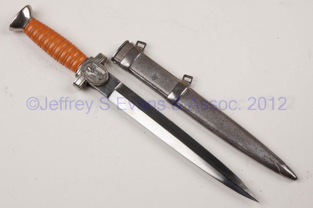GERMAN MILITARY WWII RED CROSS LEADER'S DAGGER: GERMAN MILITARY WWII RED CROSS LEADER'S DAGGER, orange-color grip, no blade markings, original scabbard. Second quarter 20th century. 9 3/4" blade, 15" LOA. Provenance: From a local estate.