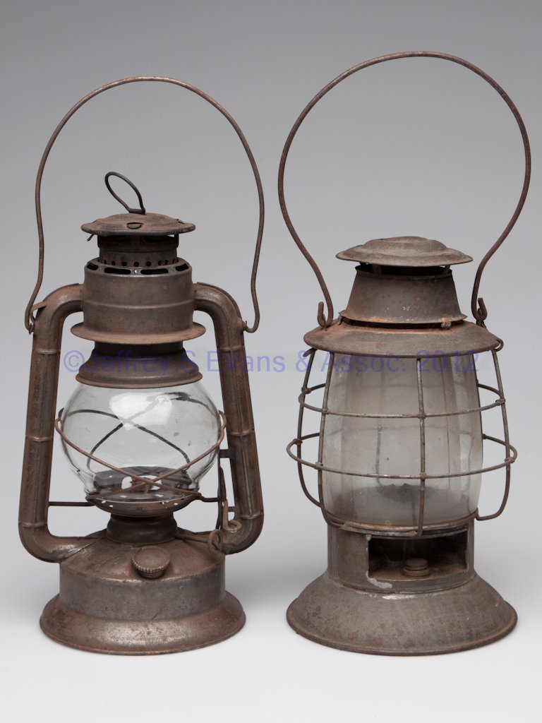 SHEET-IRON BARN LANTERNS, LOT OF TWO: SHEET-IRON BARN LANTERNS, LOT OF TWO, one marked Dietz "Little Wizard", the other unmarked, with an inner and outer glass globe. First quarter 20th century. 11" and 11 1/2" H caps. Provenance: Propert