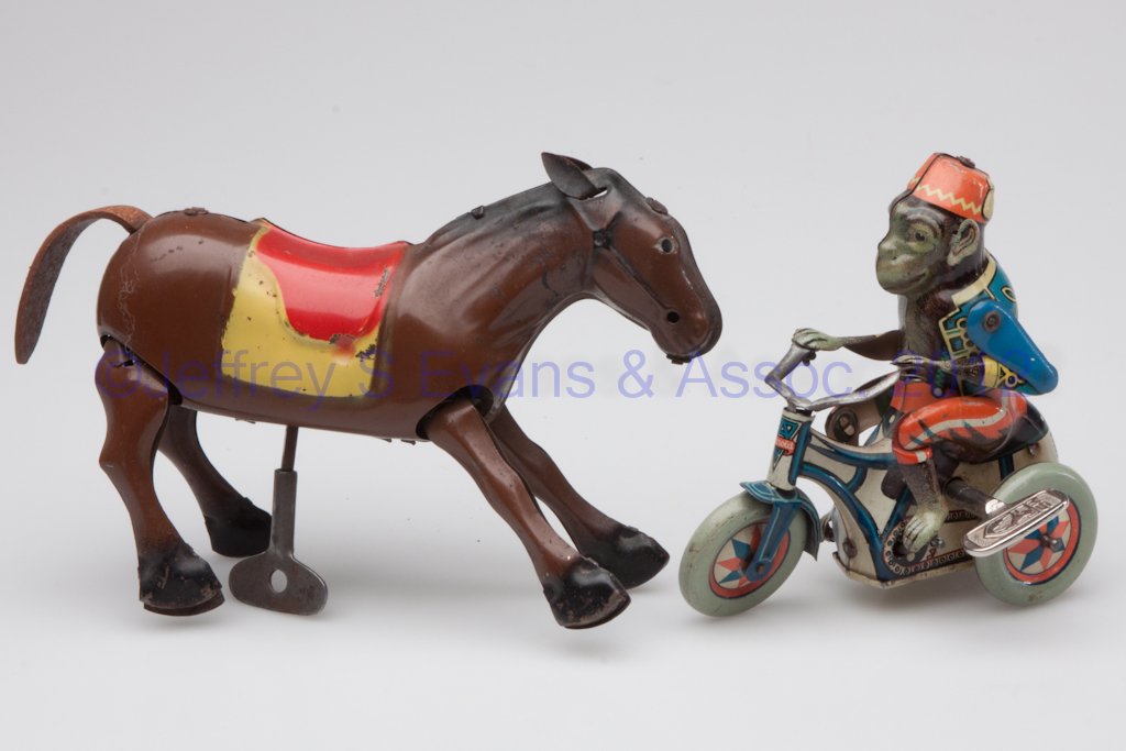WIND-UP TIN TOYS, LOT OF TWO: WIND-UP TIN TOYS, LOT OF TWO, comprising an Arnold monkey riding tricycle marked US Zone Germany, and a horse with leather tail marked Occupied Japan. Mid 20th century. 4" and 4 1/8" H.