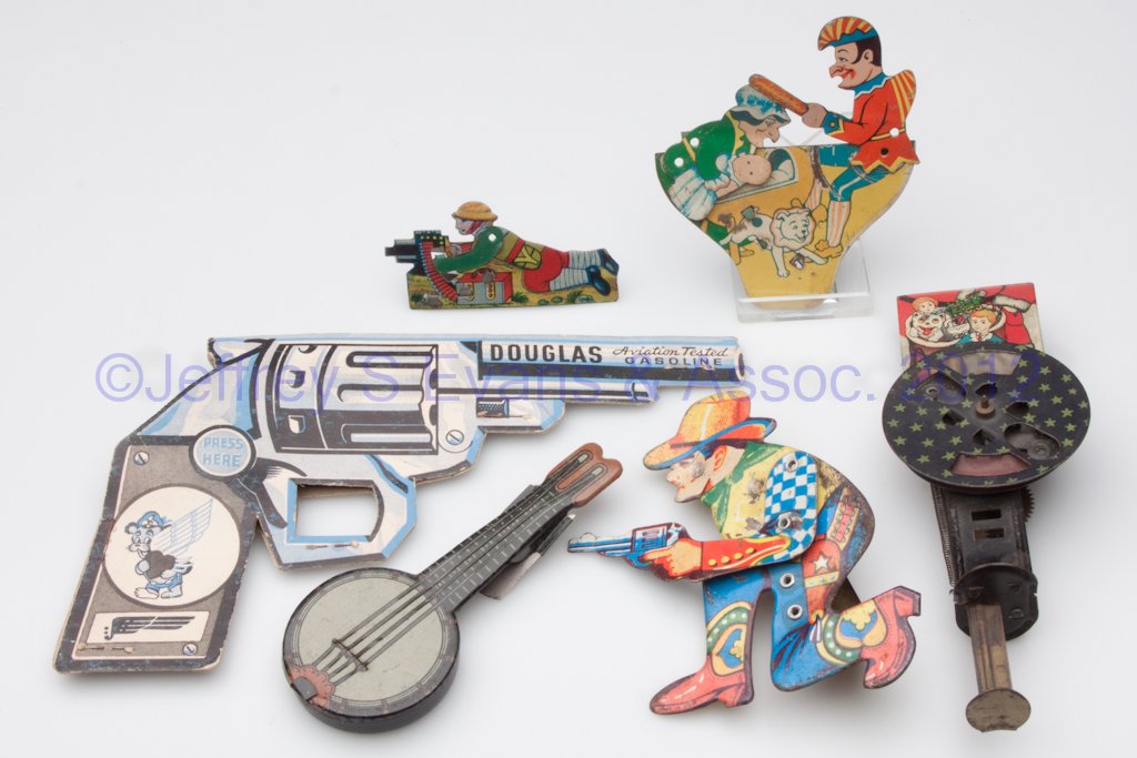 ASSORTED TOY NOISEMAKERS, LOT OF SIX: ASSORTED TOY NOISEMAKERS, LOT OF SIX, comprising four lithographed tin clickers, one paper clicker, and one lithographed tin spinner with pop-up Santa Claus. First half 20th century. Provenance: Colle