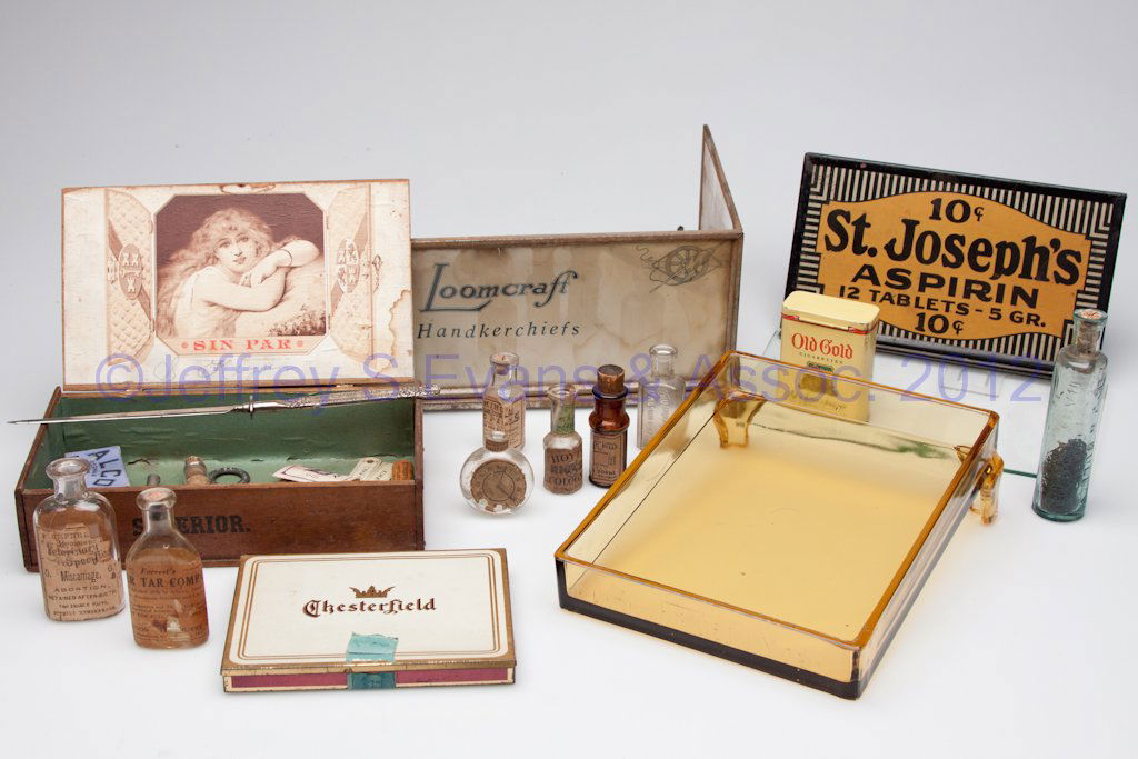 ASSORTED ADVERTISING AND COUNTRY STORE ITEMS, LOT: ASSORTED ADVERTISING AND COUNTRY STORE ITEMS, LOT OF 22, including an amber glass Clark's Teaberry Gum stand and a St. Joseph's Aspirin sign. Late 19th to mid 20th century. Provenance: From a Harrison