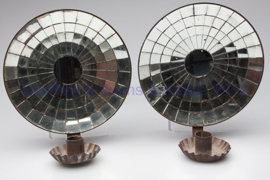 PAIR OF TIN AND MIRROR WALL SCONCES: PAIR OF TIN AND MIRROR WALL SCONCES, each with single candle socket and circular back with applied mirror blocks. 19th or 20th century. 8" D back.