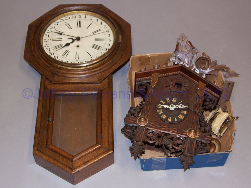 ASSORTED WALL CLOCKS, LOT OF TWO: ASSORTED WALL CLOCKS, LOT OF TWO, comprising an oak Waterbury octagon-top and a German cuckoo clock. Provenance: Property of Ruth and Rich Whipple, Roanoke, Virginia.