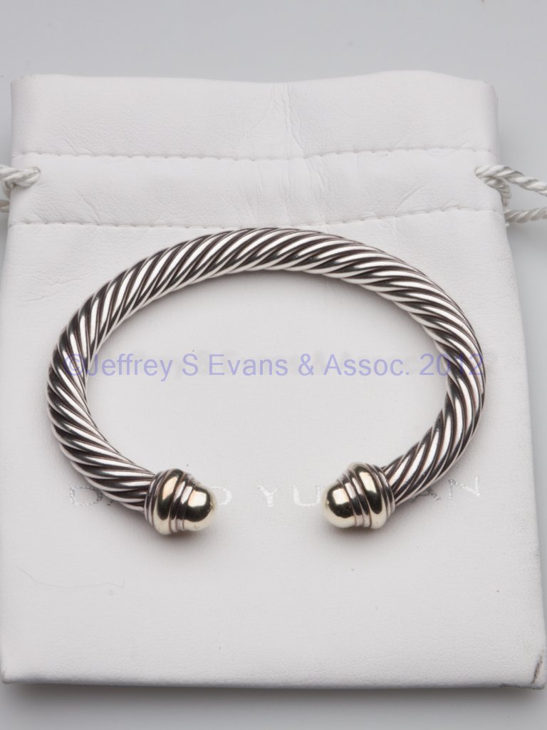 DAVID YURMAN GOLD AND STERLING SILVER BRACELET: DAVID YURMAN GOLD AND STERLING SILVER BRACELET, twisted rope cuff style, marked .585 and .925, with bag. Total weight: 1.5 ozt. 20th century. 2 1/2" x 3".