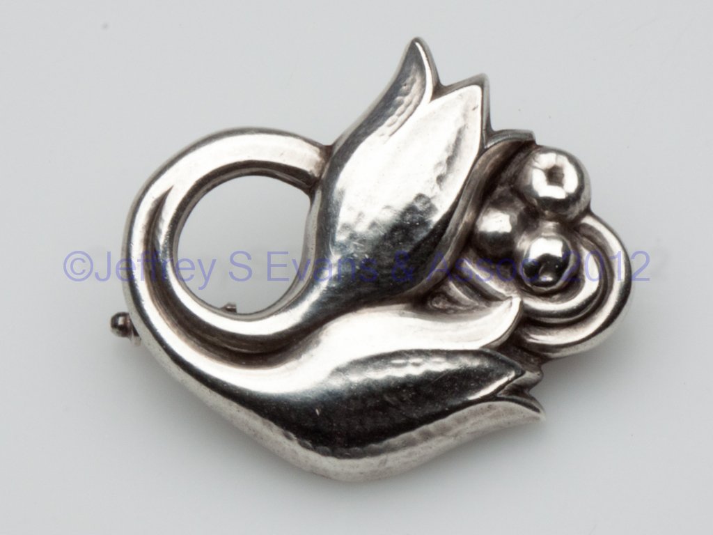 GEORG JENSEN SILVER BROOCH: GEORG JENSEN SILVER BROOCH, double lily design, stamped "830 / Denmark / Georg Jensen / 100" on back. Mid 20th century. 1 1/4" x 1 3/8". Provenance: Property of a Page Co., Virginia family.