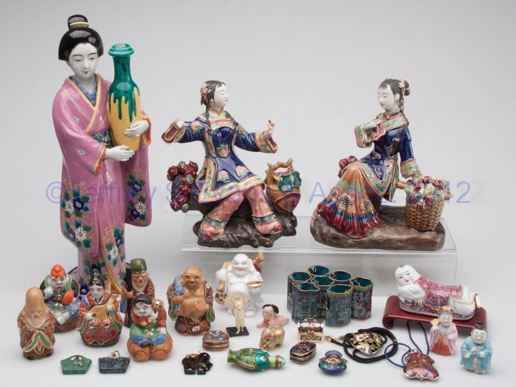 ASSORTED JAPANESE AND CHINESE DECORATIVE OBJECTS,: ASSORTED JAPANESE AND CHINESE DECORATIVE OBJECTS,, approximately 33 pieces, including ceramic figures and cloisonné jewelry. 20th century. Largest 14 1/2" H. Provenance: From the collection of the la