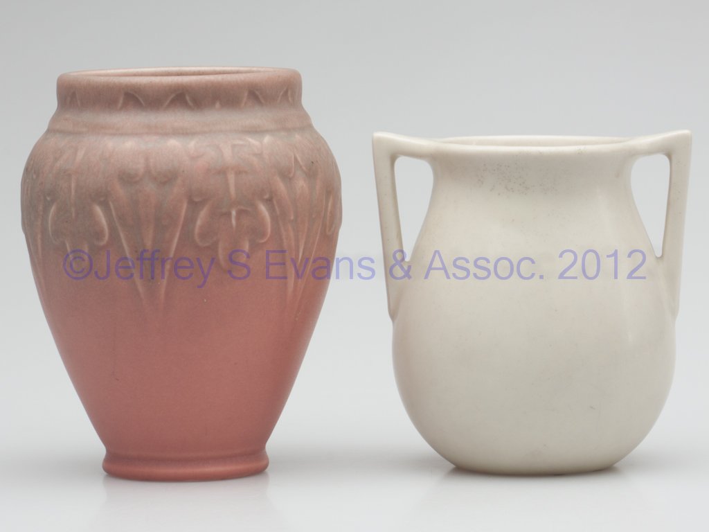 ROOKWOOD ART POTTERY VASES, LOT OF TWO: ROOKWOOD ART POTTERY VASES, LOT OF TWO, pink and white matte glaze, comprising one with two handles, and one with an embossed design at the shoulder, each with appropriate marks, including XXXII and 6
