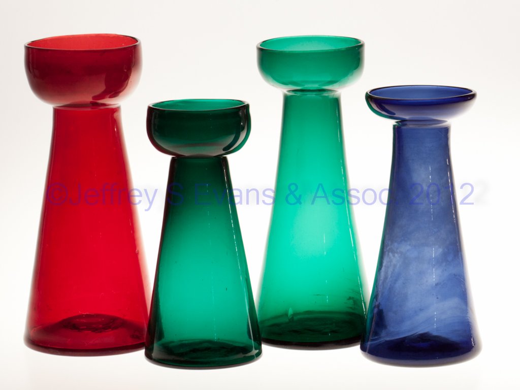 BLOWN AND MOLDED HYACINTH VASES, LOT OF FOUR: BLOWN AND MOLDED HYACINTH VASES, LOT OF FOUR, blue, green and ruby stained lead glass, each of tall conical form with rough pontil mark. Second half 19th century. 6 5/8" to 8" H. Provenance: From the 