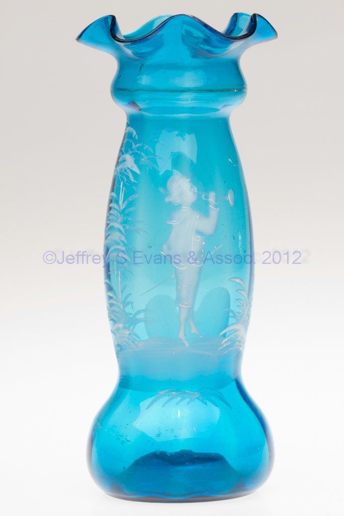 MARY GREGORY (SO CALLED) RIB-OPTIC HYACINTH VASE: MARY GREGORY (SO CALLED) RIB-OPTIC HYACINTH VASE, blue with white decoration and worn gilding, featuring a boy wearing a sword and playing a horn, rough pontil mark. Late 19th/early 20th century. 8 1/
