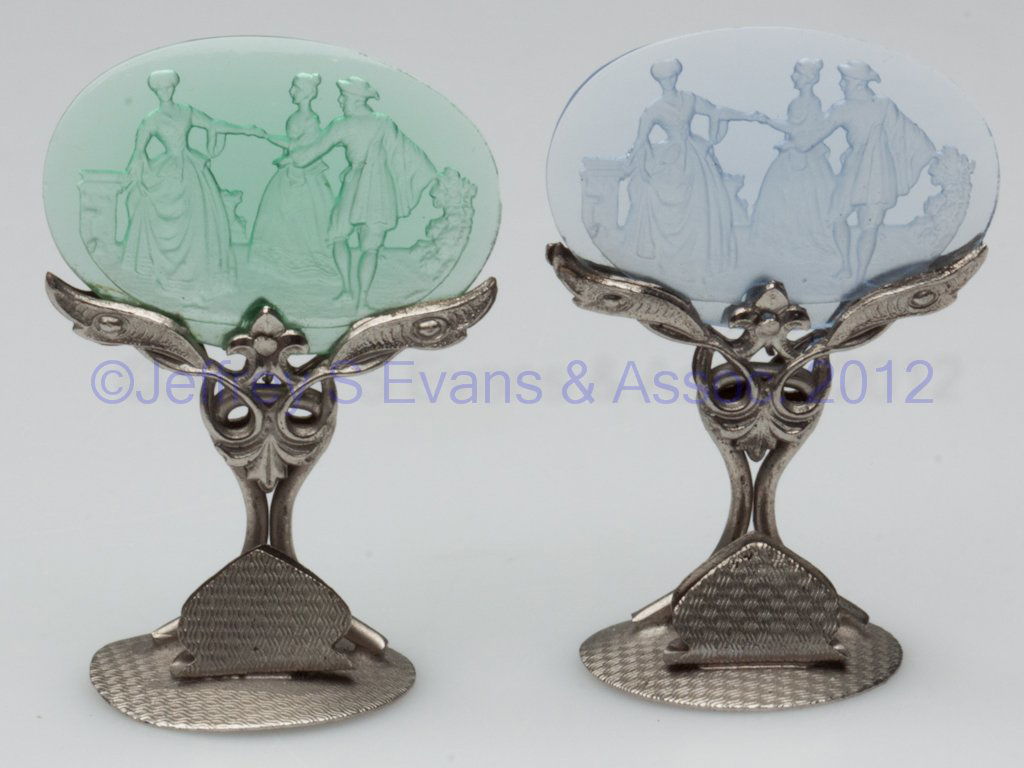 CZECHOSLOVAKIA INTAGLIO GLASS PLACECARD HOLDERS, L: CZECHOSLOVAKIA INTAGLIO GLASS PLACECARD HOLDERS, LOT OF TWO, green and blue, in matching stands marked underneath. First half 20th century. 2" H. Provenance: Property of a Page Co., Virginia family.