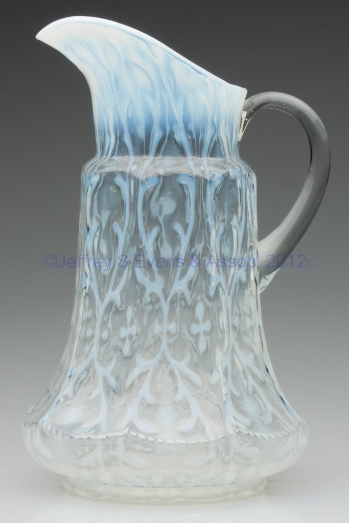 OPALINE BROCADE / SPANISH LACE - EIGHT-PANEL MOLD: OPALINE BROCADE / SPANISH LACE - EIGHT-PANEL MOLD TANKARD WATER PITCHER, colorless opalescent, colorless applied handle. Late 19th/early 20th century. 11 1/2" HOA.