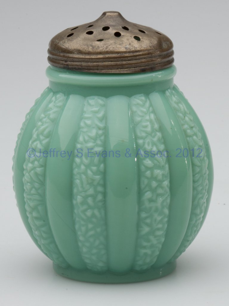 SCROLLED RIB SUGAR SHAKER: SCROLLED RIB SUGAR SHAKER, opaque green, period lid. Gillinder & Sons. Late 19th/early 20th century. 4 1/4" HOA.
