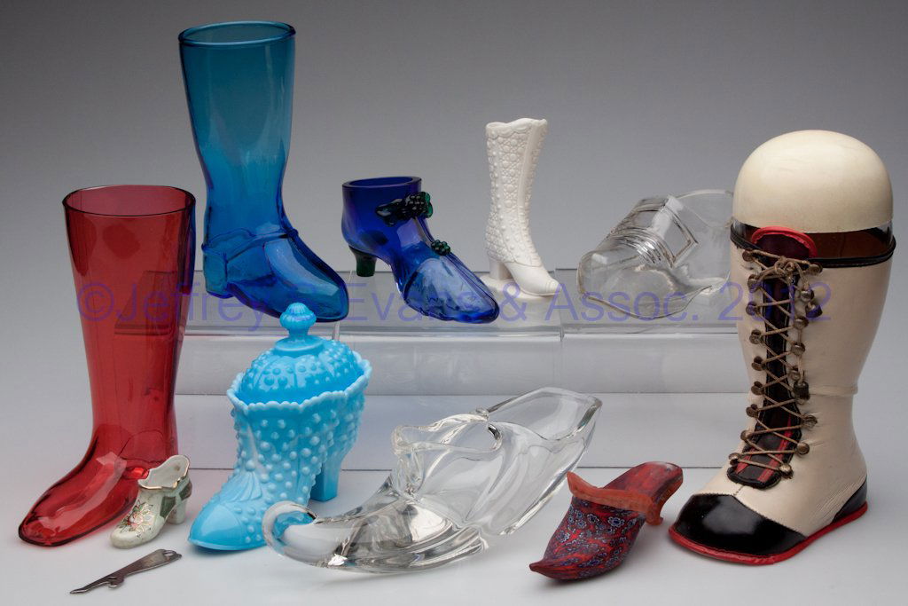 ASSORTED MATERIALS FIGURAL SHOES / BOOTS, LOT OF 1: ASSORTED MATERIALS FIGURAL SHOES / BOOTS, LOT OF 11, including glass, ceramic and metal, two with covers. 20th century. 1 1/2" to 10" H. Provenance: From a Michigan estate collection.