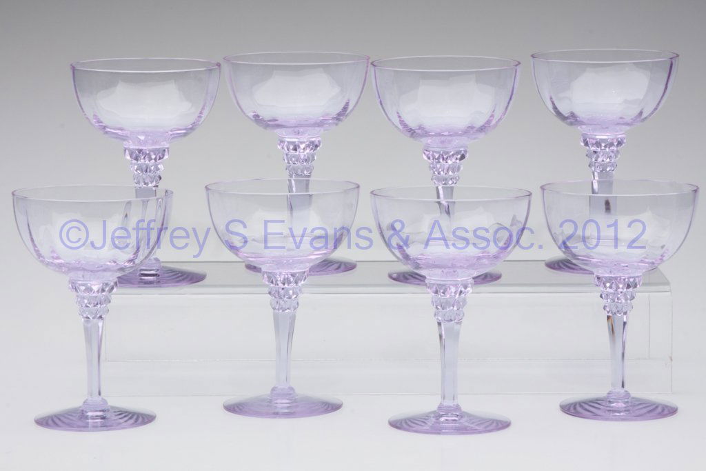 TIFFIN RIBBED OPTIC SAUCER CHAMPAGNES, SET OF EIGH: TIFFIN RIBBED OPTIC SAUCER CHAMPAGNES, SET OF EIGHT, Twilight/Alexandrite color, stem #17501. Tiffin Glass Co. Third quarter 20th century. 5 1/2" H. Provenance: From a private Florida collector.