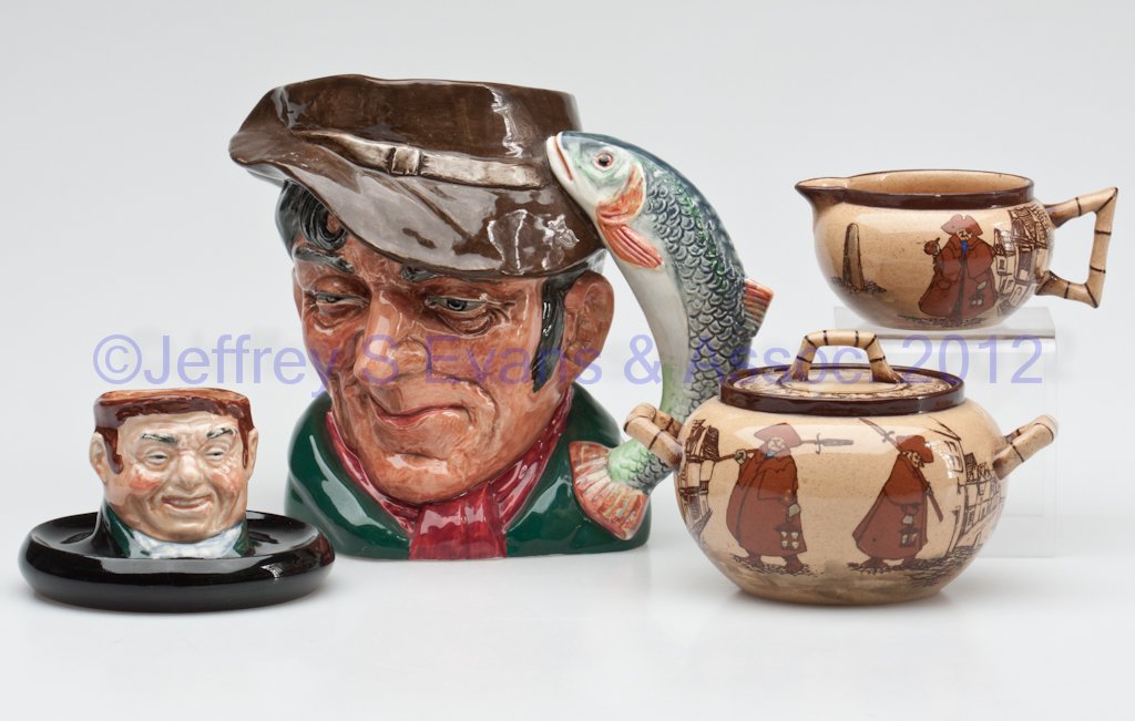 ROYAL DOULTON ARTICLES, LOT OF FOUR: ROYAL DOULTON ARTICLES, LOT OF FOUR, polychrome decoration, comprising "The Poacher" jug, No. 6429, a match holder, and a matching covered sugar and creamer, depicting night watchmen on their rounds, 