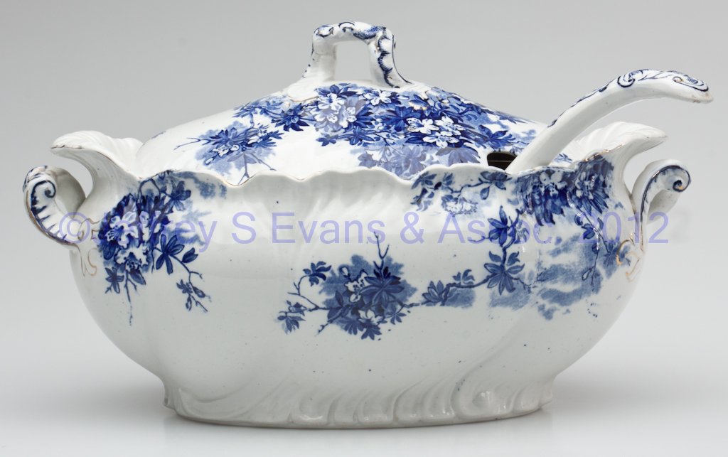 STAFFORDSHIRE TRANSFERWARE TUREEN WITH LADLE: STAFFORDSHIRE TRANSFERWARE TUREEN WITH LADLE, blue on white with some gilt decoration, base with underglaze mark for Booths, and "AZALEA PATTERN". Late 19th/early 20th century. 8" HOA, 7 1/2" x 12 1/2