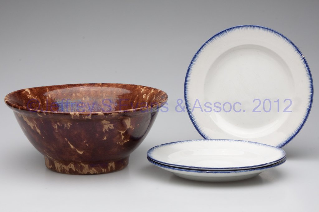 ASSORTED COUNTRY CERAMIC ARTICLES, LOT OF FOUR: ASSORTED COUNTRY CERAMIC ARTICLES, LOT OF FOUR, comprising a yellowware mixing bowl with brown sponge decoration, and three English blue-edge plates. 19th century. 10 1/2" and 8 1/2" D. Provenance: Th