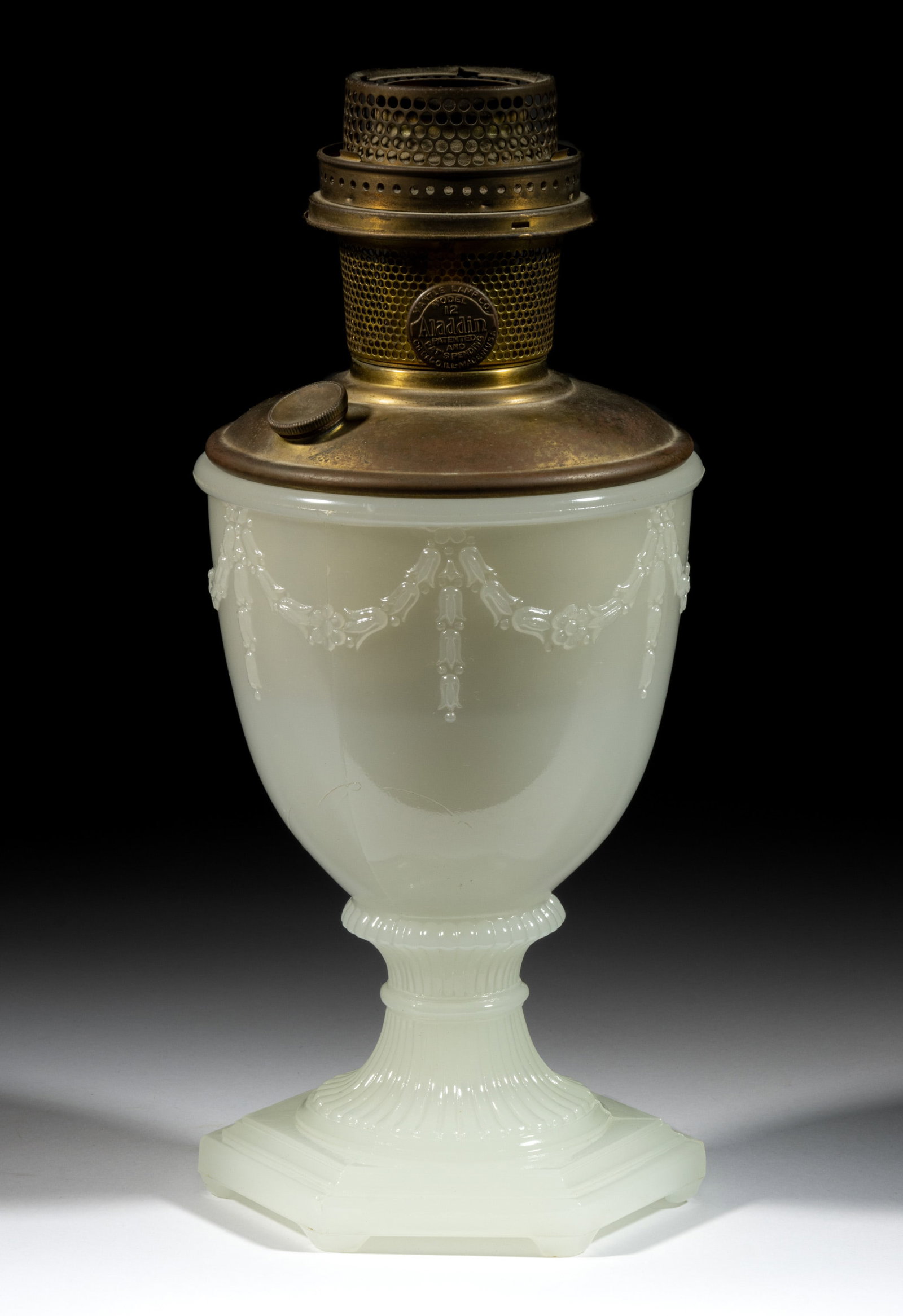 ALADDIN MODEL NO. 177 / FLORENTINE KEROSENE VASE LAMP: ALADDIN MODEL NO. 177 / FLORENTINE KEROSENE VASE LAMP, White Moonstone, urn-form vase with drapery around the bowl lacking interior paint, ribbed and waisted standard, hexagonal foot. Fitted