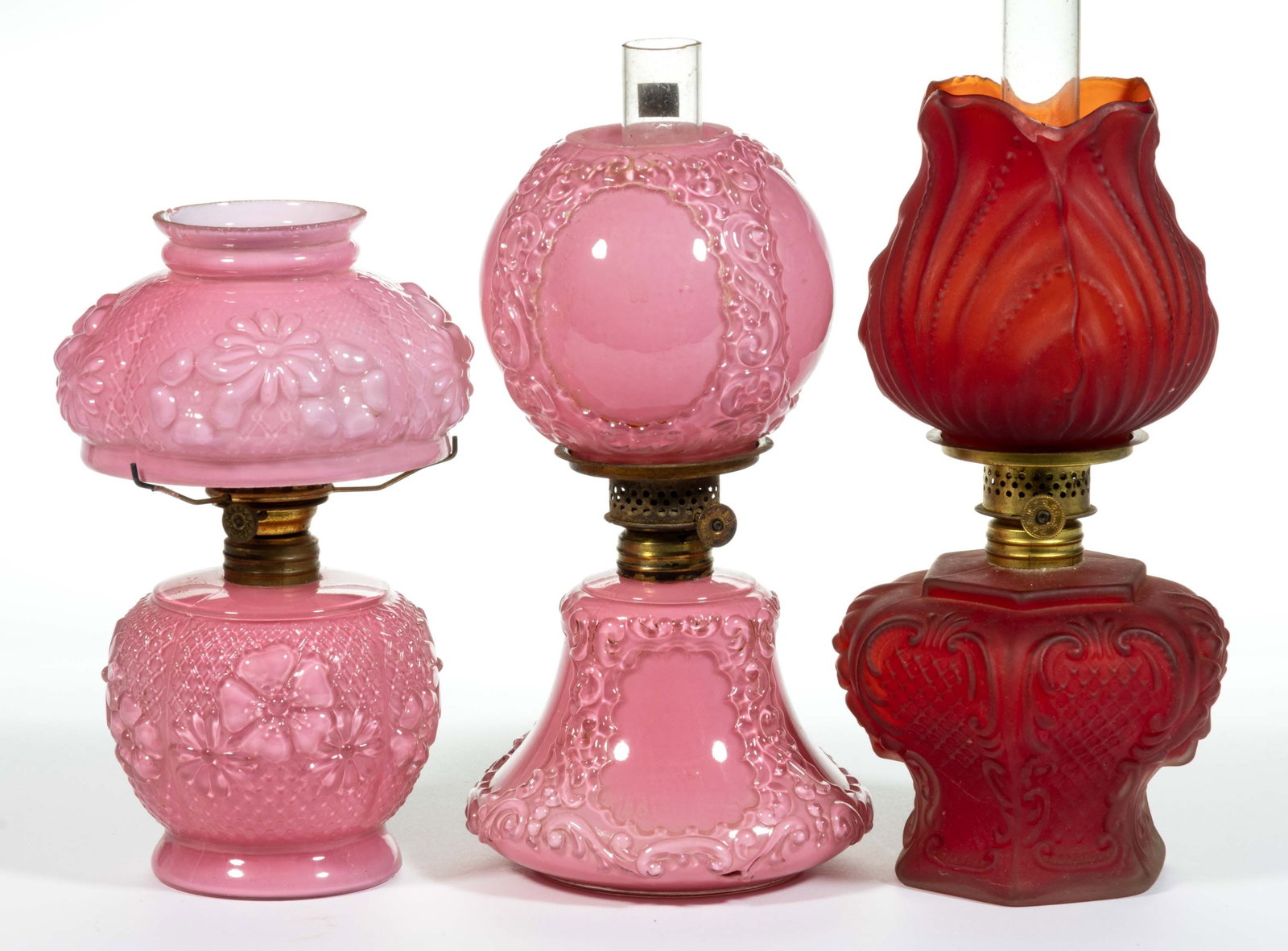 ASSORTED CASED GLASS MINIATURE LAMPS, LOT OF THREE: ASSORTED CASED GLASS MINIATURE LAMPS, LOT OF THREE, comprising two cased pink examples, patterns include Daisy/Smith I, fig. 206 and an embossed scroll patterned/Smith I, fig. 379 example; and a