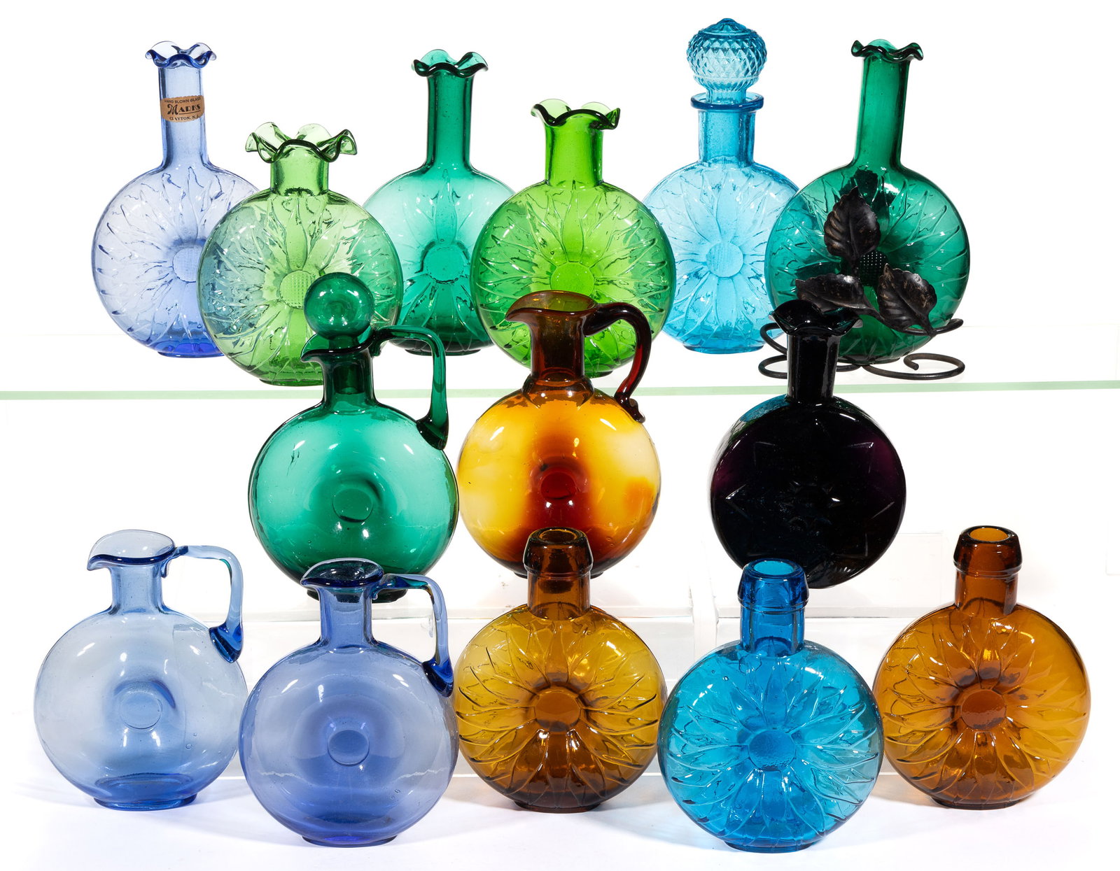 CLEVENGER BROTHERS BLOWN-MOLDED SUNFLOWER PINCH BOTTLES / VASES AND OTHERS, LOT OF 14: CLEVENGER BROTHERS BLOWN-MOLDED SUNFLOWER PINCH BOTTLES / VASES AND OTHERS, LOT OF 14, medium blue, medium green, amethyst, amber, nine examples blown-molded with sunflower design, one with an ei