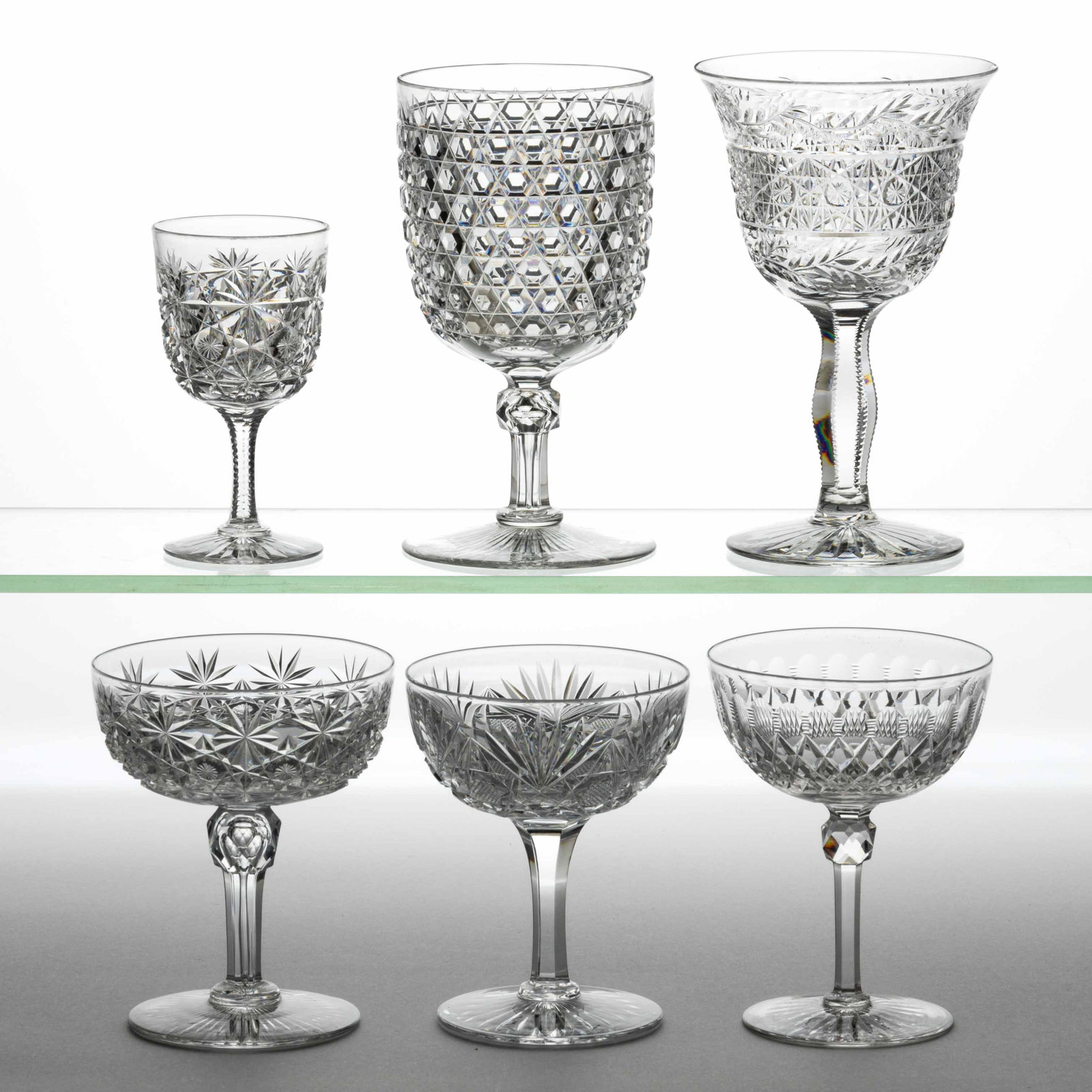 DORFLINGER ATTRIBUTED CUT GLASS DRINKING VESSELS, LOT OF SIX: DORFLINGER ATTRIBUTED CUT GLASS DRINKING VESSELS, LOT OF SIX, colorless, including a Hob Diamond goblet, a Russian champagne, and wine, and a Diamond champagne. Dorflinger and possibly others. Fourth