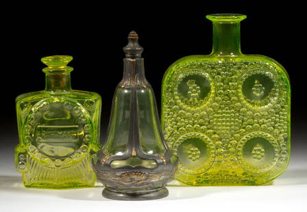 FINNISH RIIHIMAEN VASELINE GLASS BOTTLES, LOT OF TWO: FINNISH RIIHIMAEN VASELINE GLASS BOTTLES, LOT OF TWO, Vaseline (reacts under black light), consisting of a square-form &quot;grapponia&quot; decanter designed by Nanny Still, and a smaller train-shape