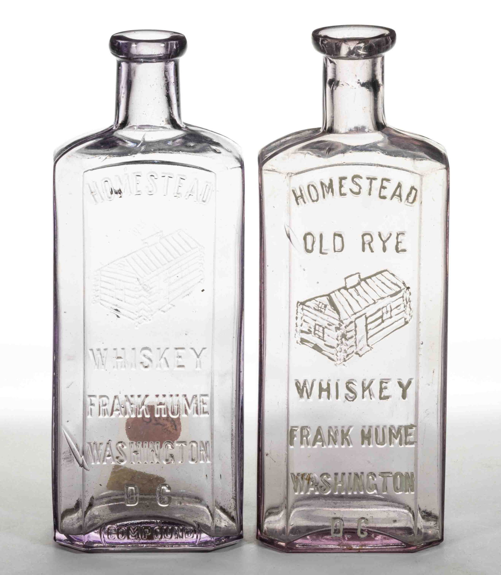 HOMESTEAD OLD RYE WHISKEY, WASHINGTON, DC PICTORIAL FLASKS / BOTTLES, LOT OF TWO: HOMESTEAD OLD RYE WHISKEY, WASHINGTON, DC PICTORIAL FLASKS / BOTTLES, LOT OF TWO, colorless both with moderate sun-colored amethyst tint, rectangular druggist form with beveled corners, embo