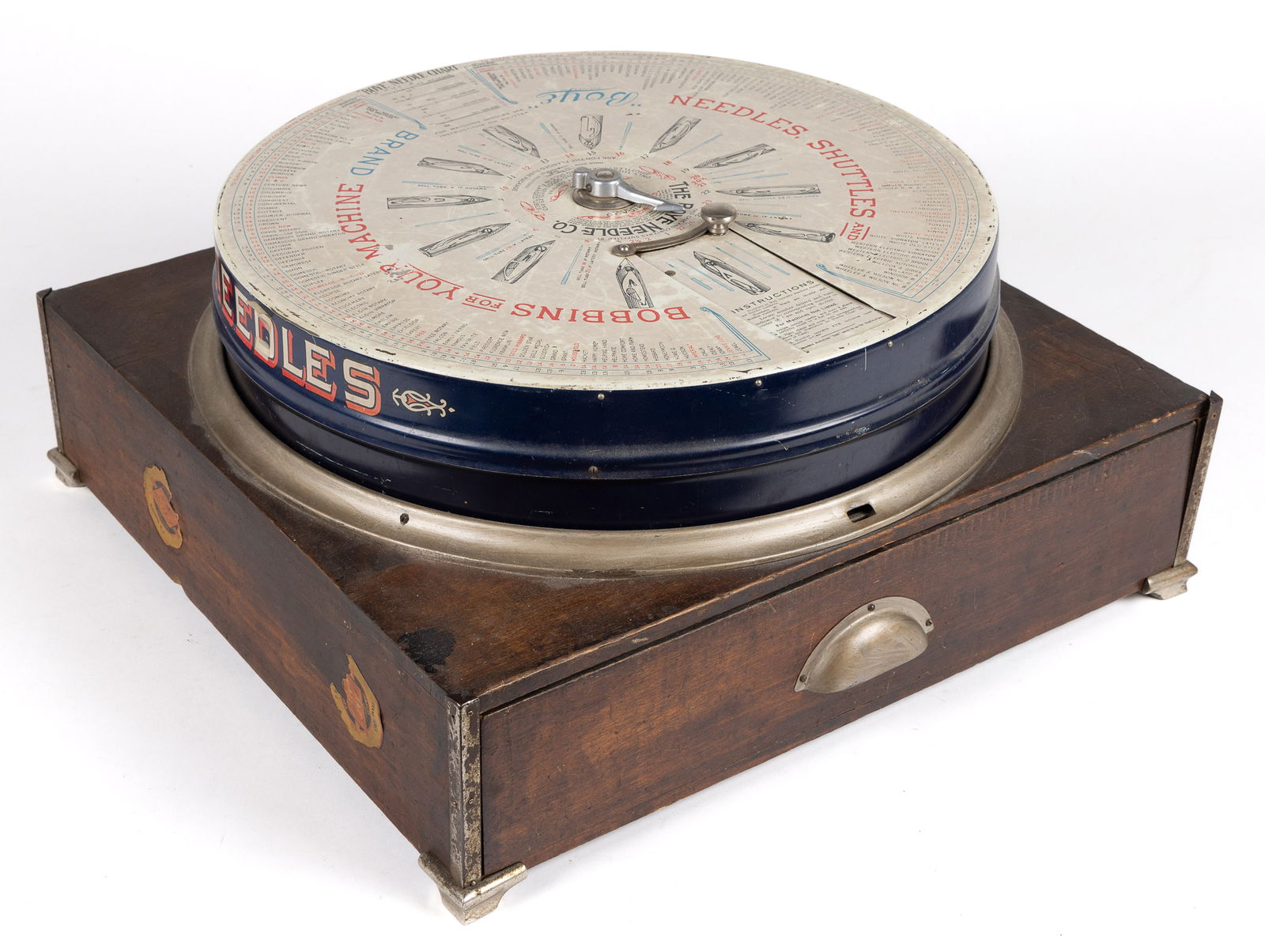 BOYE NEEDLE COMPANY STORE DISPLAY CABINET / ROTARY CASE: BOYE NEEDLE COMPANY STORE DISPLAY CABINET / ROTARY CASE, lithographed tin rotary cabinet on wooden base with drawer, retains many needles and shuttle cases. First half of 20th century. Boye Needle Com