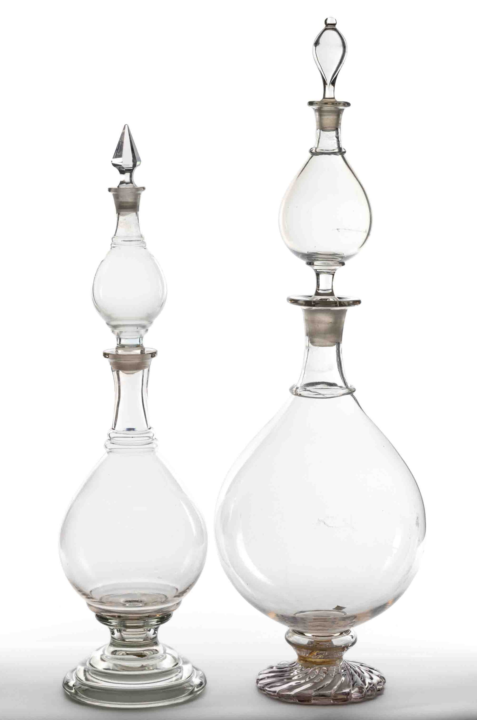 APOTHECARY SHOW GLOBES / GLASS JARS, LOT OF TWO: APOTHECARY SHOW GLOBES / GLASS JARS, LOT OF TWO, colorless, blown in two sections, each section having a baluster-form body with single or double neck rings, one example blown-molded with a 