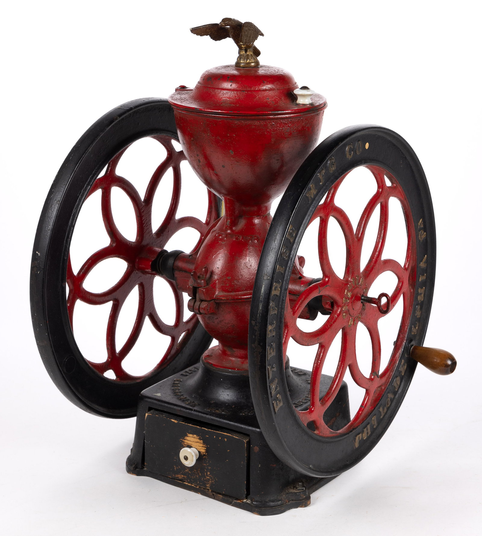 ENTERPRISE TWO-WHEEL CAST-IRON COFFEE MILL / GRINDER: ENTERPRISE TWO-WHEEL CAST-IRON COFFEE MILL / GRINDER, swivel lid with large eagle finial, wooden base and old painted surface. Enterprise Mfg. Co., Philadelphia, PA. Fourth quarter 19th century. 24&qu
