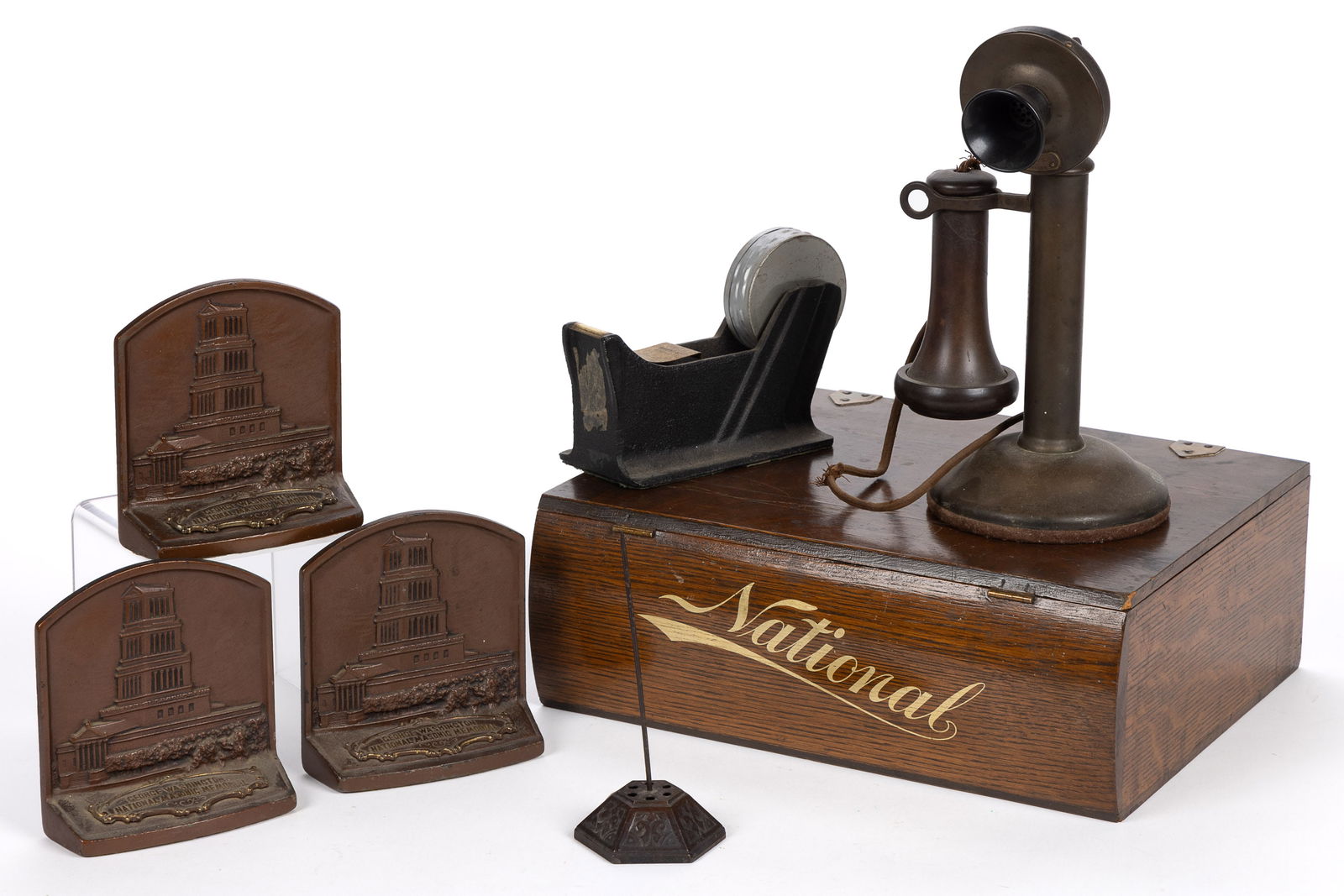ASSORTED COUNTRY STORE ARTICLES, LOT OF SEVEN: ASSORTED COUNTRY STORE ARTICLES, LOT OF SEVEN, consisting of a brass candlestick phone, a tape dispenser, a receipt spindle, three bookends from the George Washington National Memorial, and an oak&nbs
