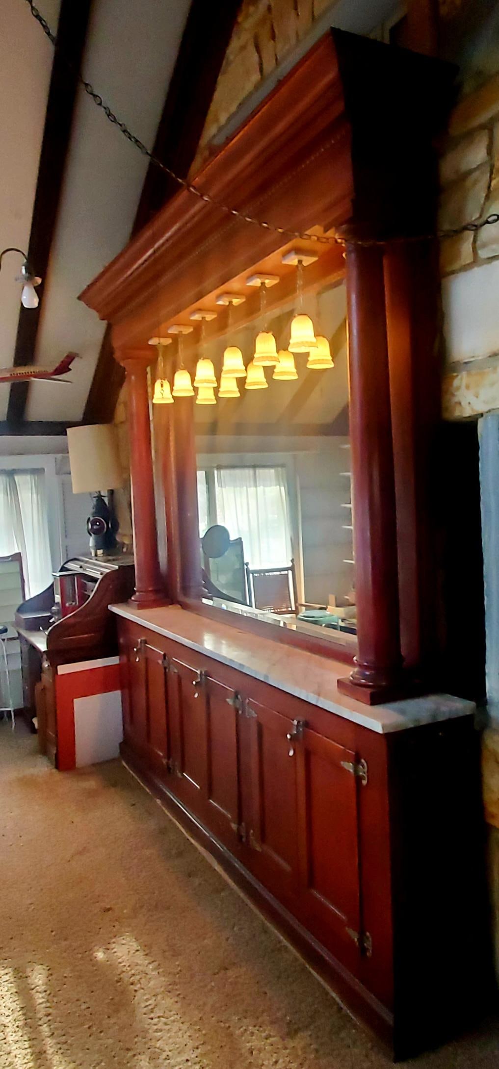 PENNSYLVANIA VICTORIAN DRUG STORE MARBLE-TOP BACK BAR: PENNSYLVANIA VICTORIAN DRUG STORE MARBLE-TOP BACK BAR, mahogany-stained maple, the ogee-molded cornice with egg-and-dart ornaments above the bow-front frieze, raised on two tapered front columns