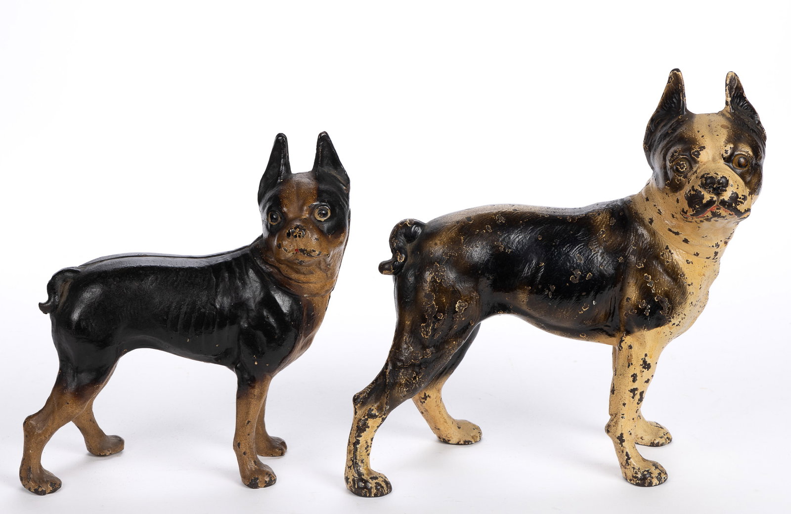 HUBLEY CAST-IRON BOSTON TERRIER DOG DOORSTOPS, LOT OF TWO: HUBLEY CAST-IRON BOSTON TERRIER DOG DOORSTOPS, LOT OF TWO, hollow full-body form depicting Boston terriers, cast in a two-part mold, retaining likely original polychrome painted surfaces. La