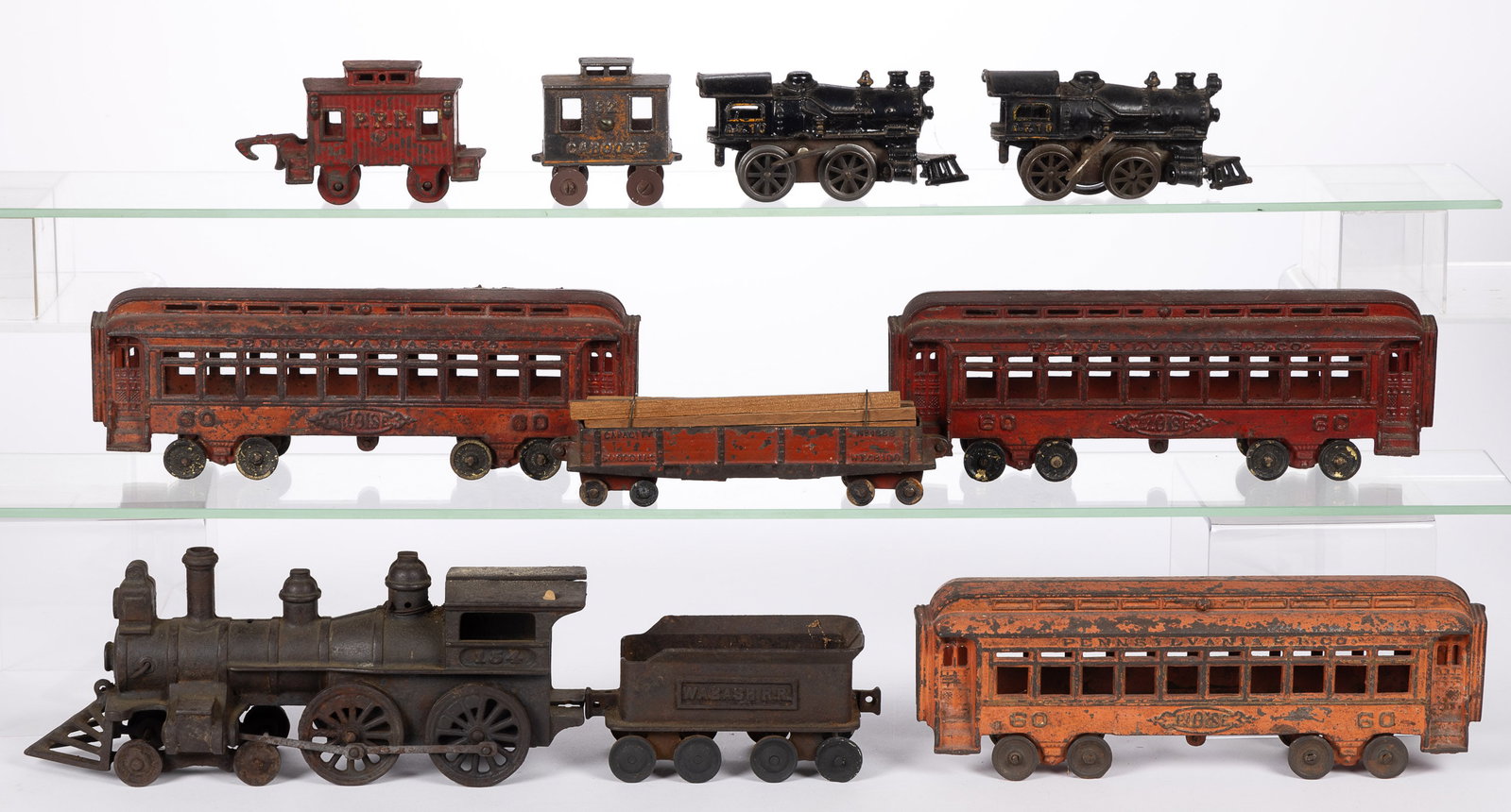 IDEAL AND OTHERS, CAST-IRON TRAIN CARS, LOT OF TEN: IDEAL AND OTHERS, CAST-IRON TRAIN CARS, LOT OF TEN, including two wind-up examples, three passenger cars marked "PENNSYLVANIA R.R. CO. / ELOISE", and an engine with coal car marked "WAB