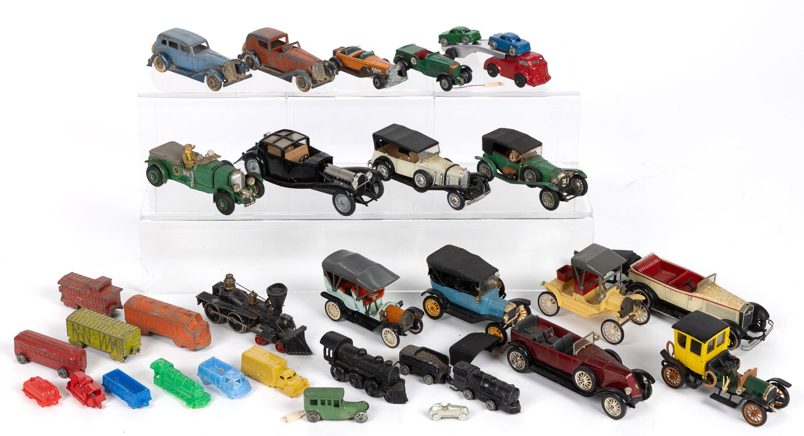 VINTAGE TOY AND MODEL CARS / TRAINS, LOT OF 29: VINTAGE TOY AND MODEL CARS / TRAINS, LOT OF 29, including metal and plastic examples, some of which are marked "MADE IN USA", forms include train engines and cars, a wrecker with two ca
