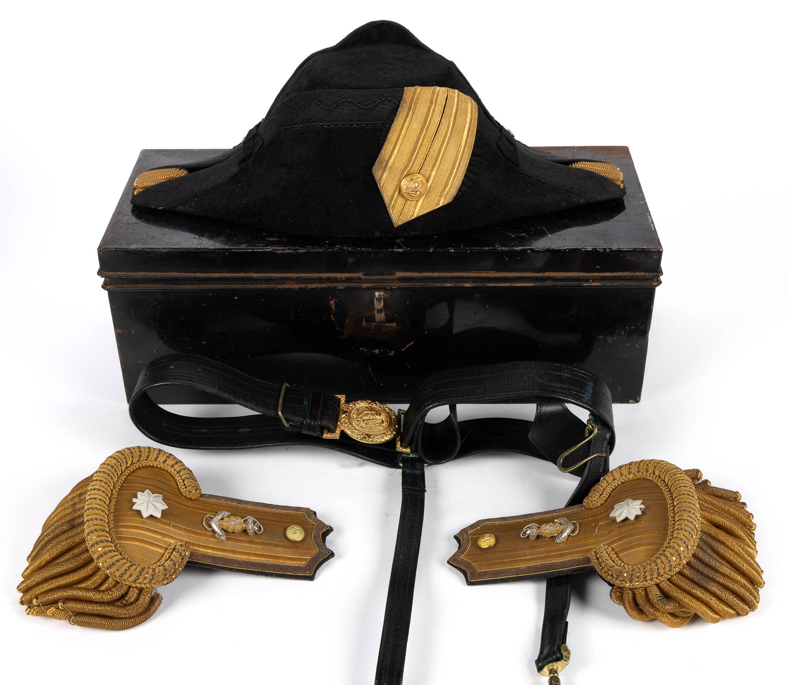 U. S. NAVAL OFFICER'S BICORN HAT, EPAULETTES, AND BELT IN ORIGINAL CASE: U. S. NAVAL OFFICER'S BICORN HAT, EPAULETTES, AND BELT IN ORIGINAL CASE, richly ornamented hat and epaulettes with gold-colored and silver-colored threading. Marked "FRANCE" to underside