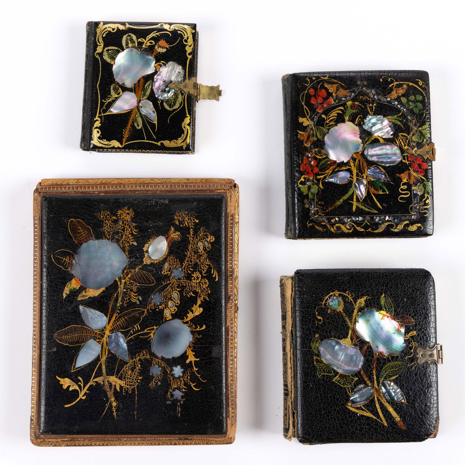 PAPIER-MACHE WITH ABALONE / MOTHER-OF-PEARL IMAGE CASES, LOT OF FOUR: PAPIER-MACHE WITH ABALONE / MOTHER-OF-PEARL IMAGE CASES, LOT OF FOUR, each with floral motif, comprising one sixth plate example with additional silver wire inlay and polychrome hand-painted deco