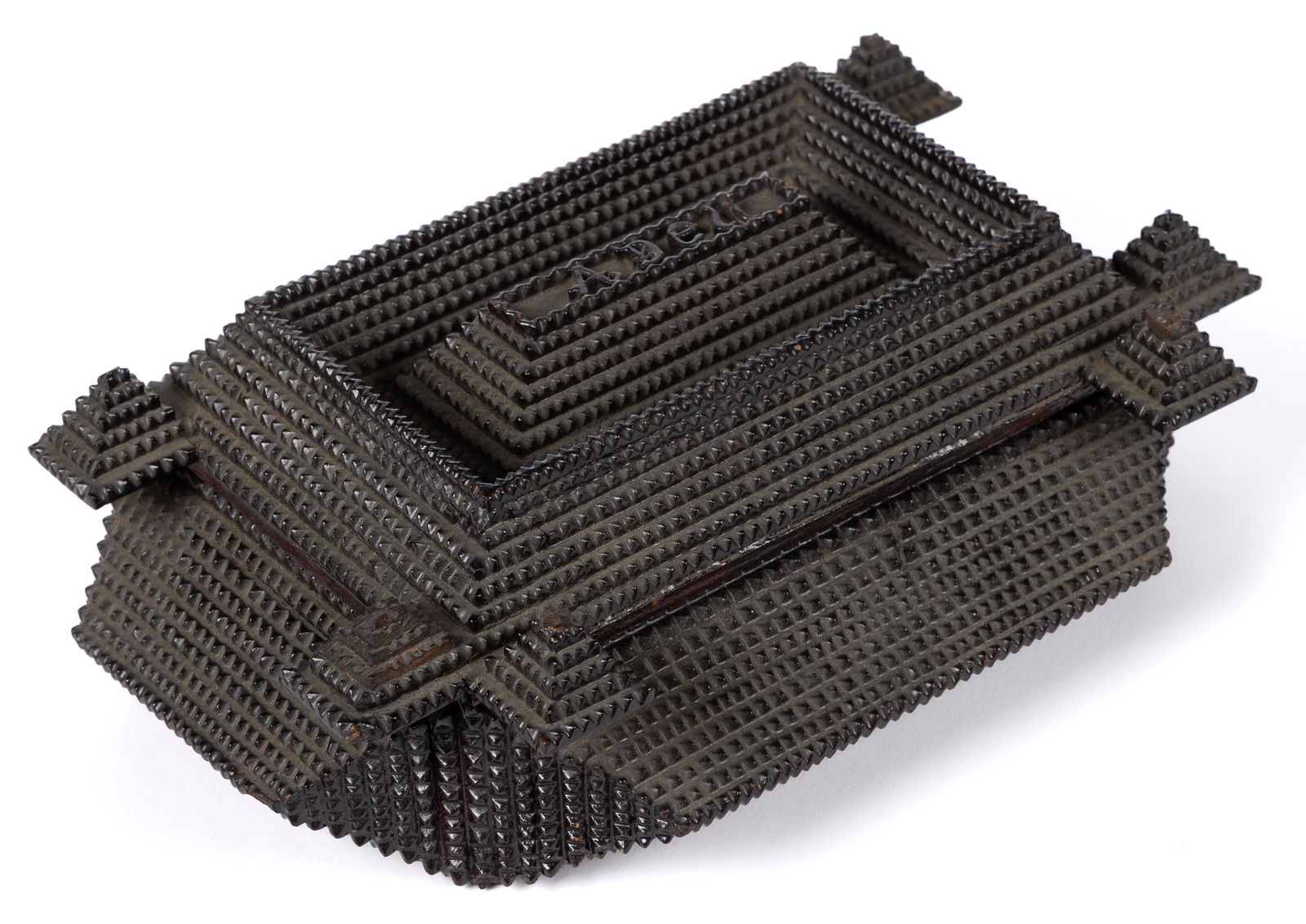 AMERICAN CHIP-CARVED TRAMP ART DRESSER BOX: AMERICAN CHIP-CARVED TRAMP ART DRESSER BOX, the hinged lid with extended corners and "A Dell" carved to the raised center, concealing a velvet-lined interior featuring a cabinet photo of a s