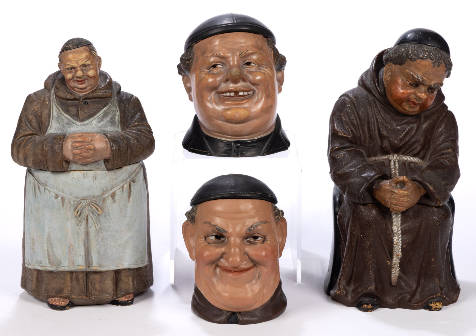 CONTINENTAL CERAMIC FIGURAL MONK HUMIDORS, LOT OF FOUR: CONTINENTAL CERAMIC FIGURAL MONK HUMIDORS, LOT OF FOUR, each wearing a zucchetto, comprising one standing example wearing a robe with an apron, one sitting example featuring a religious figure in cont