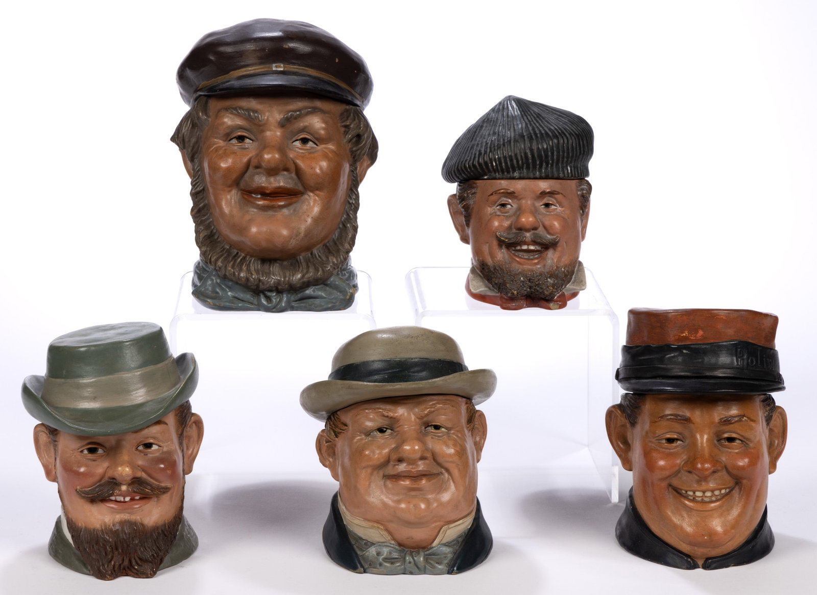 CONTINENTAL CERAMIC FIGURAL HEAD HUMIDORS, LOT OF FIVE: CONTINENTAL CERAMIC FIGURAL HEAD HUMIDORS, LOT OF FIVE, each wearing a hat including one with "Polin" to band and one wearing a beret/caubeen-style hat with a gilt upside down horseshoe