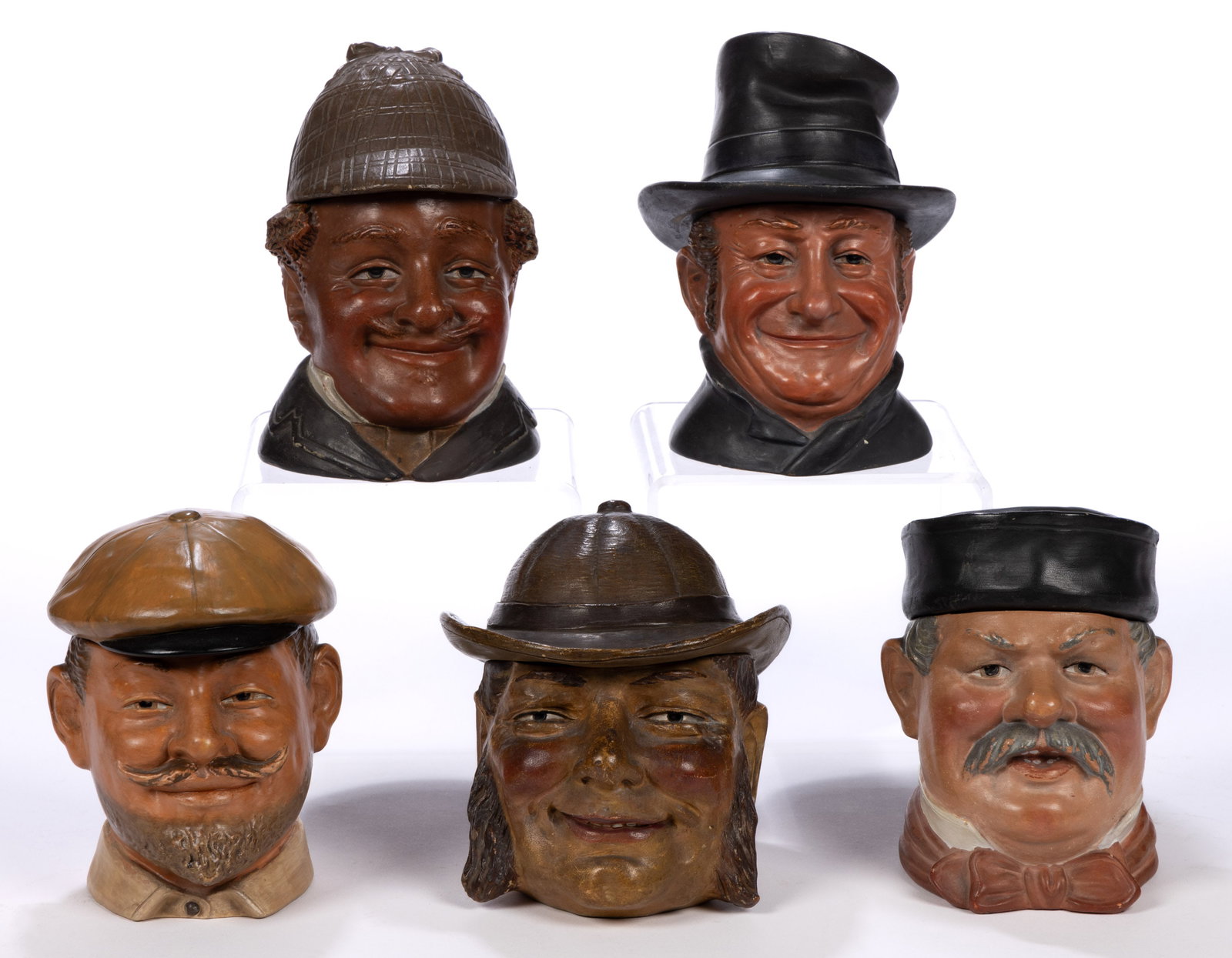 CONTINENTAL CERAMIC FIGURAL HEAD HUMIDORS, LOT OF FIVE: CONTINENTAL CERAMIC FIGURAL HEAD HUMIDORS, LOT OF FIVE, each wearing a hat including one wearing a deerstalker cap and one wearing a circular-style example, one having sponge holder top. Marks to