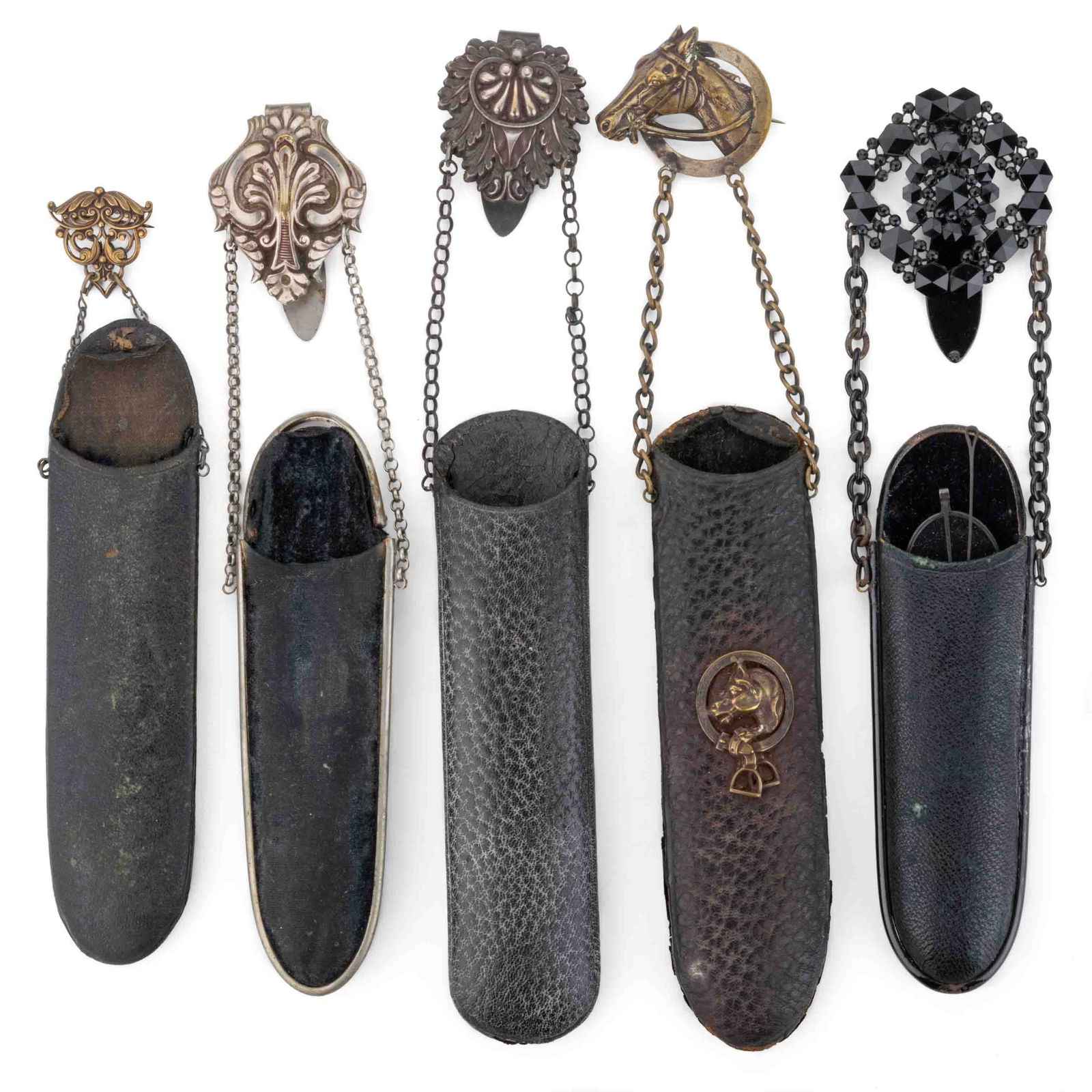 ASSORTED VICTORIAN CHATELAINE EYEGLASSES / SPECTACLES CASES, LOT OF FIVE: ASSORTED VICTORIAN CHATELAINE EYEGLASSES / SPECTACLES CASES, LOT OF FIVE, mostly hard leather or papier mache oblong bodies, each with attached metal chains and pins or clips, a couple silver-pla