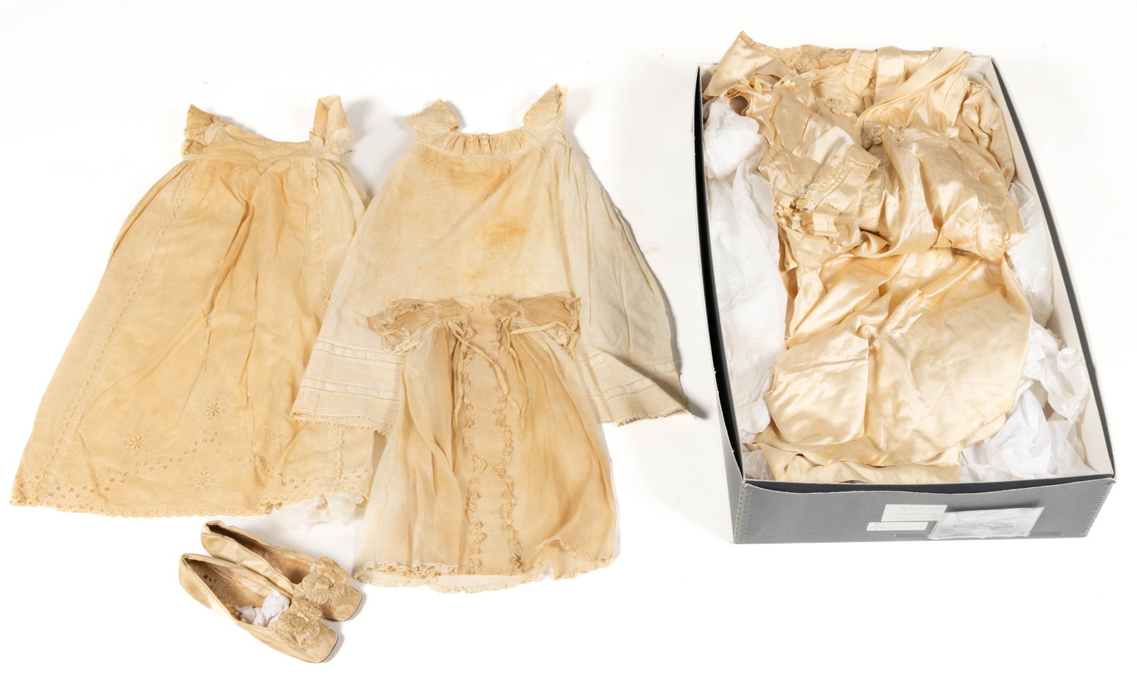 ANTIQUE WEDDING DRESS, SHOES, AND BABY CLOTHING, LOT OF SIX: ANTIQUE WEDDING DRESS, SHOES, AND BABY CLOTHING, LOT OF SIX, comprising a white silk wedding dress with short sleeves and lace inset at top of bodice, a pair white silk wedding shoes with short heels 