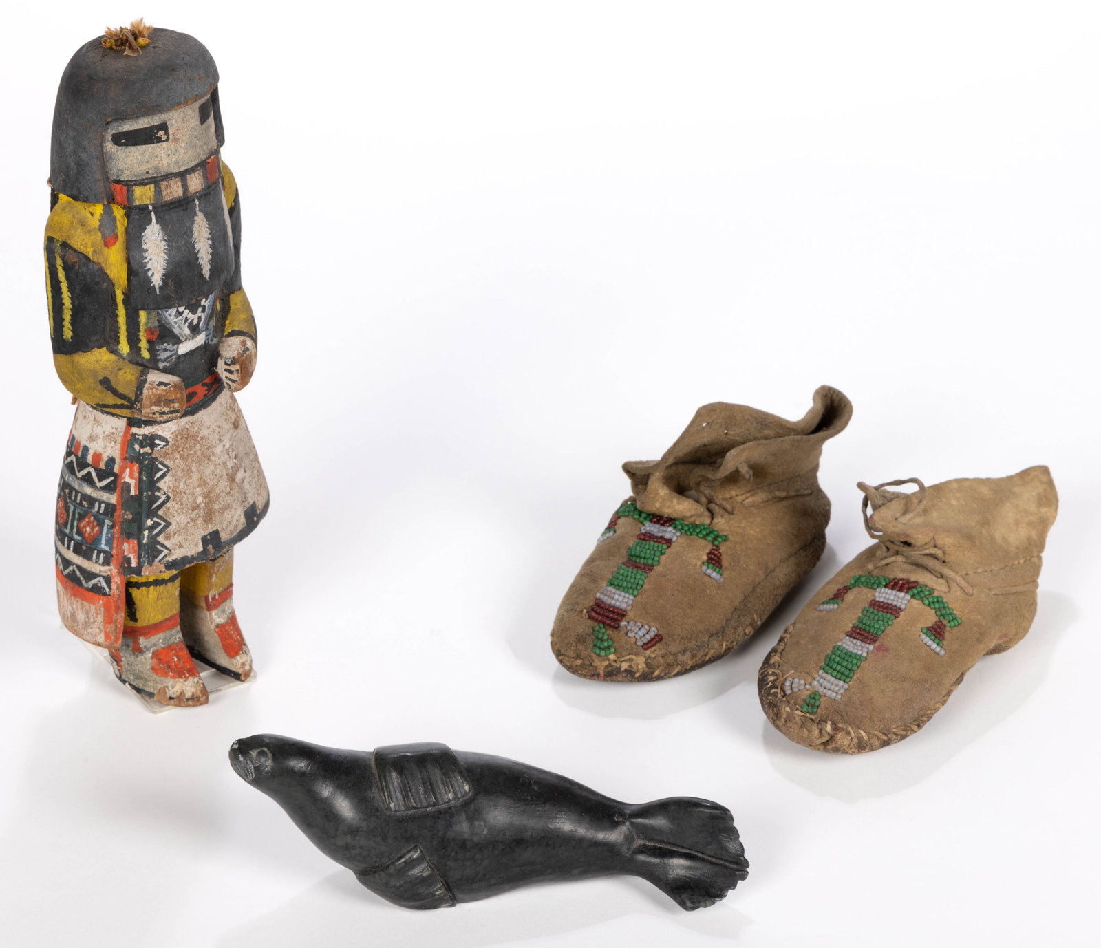 NATIVE AMERICAN AND CANADIAN INUIT ARTICLES, LOT OF FOUR: NATIVE AMERICAN AND CANADIAN INUIT ARTICLES, LOT OF FOUR, comprising a carved wood Hopi Kachina doll with polychrome painted surface featuring a squash blossom necklace, a pair of Plains Indian child&
