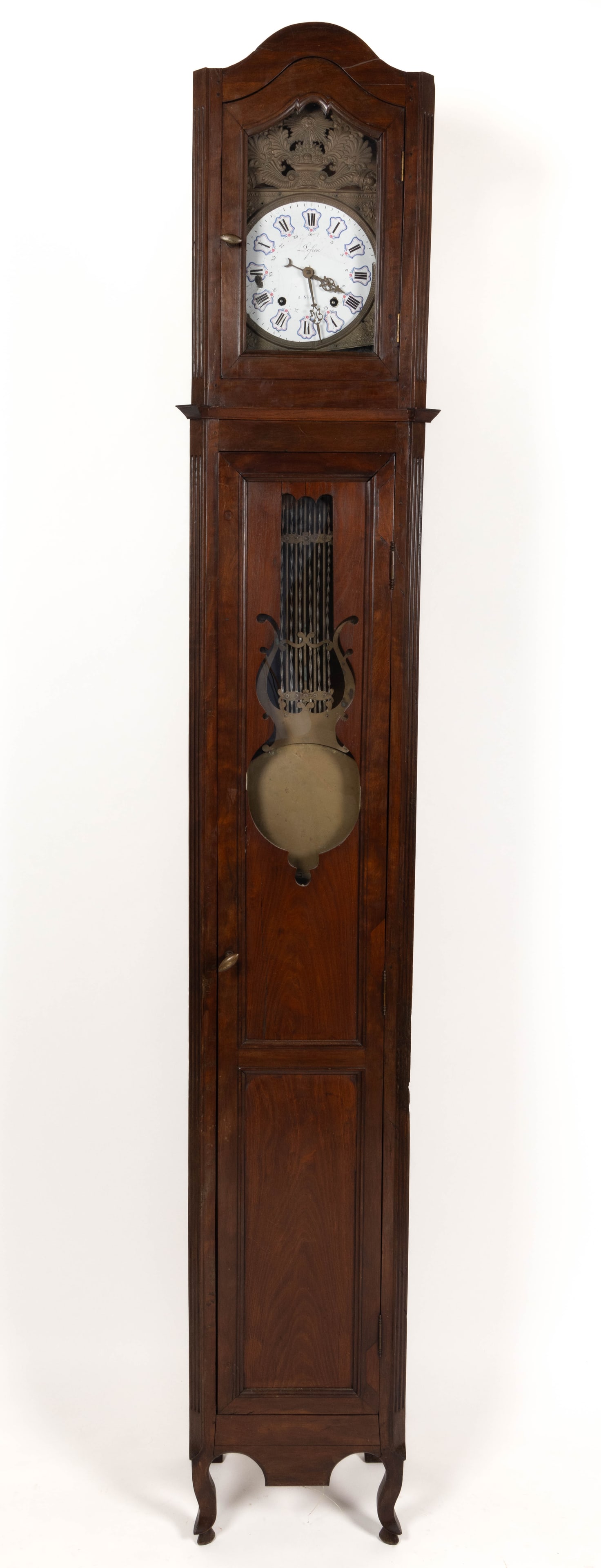 FRENCH PROVINCIAL LONG CASE CLOCK: FRENCH PROVINCIAL LONG CASE CLOCK, walnut and pine secondary, Morbier style with enamel face and brass surround, multi-section case with raised front panels, pendulum, and key. Lacking weights. 19th c