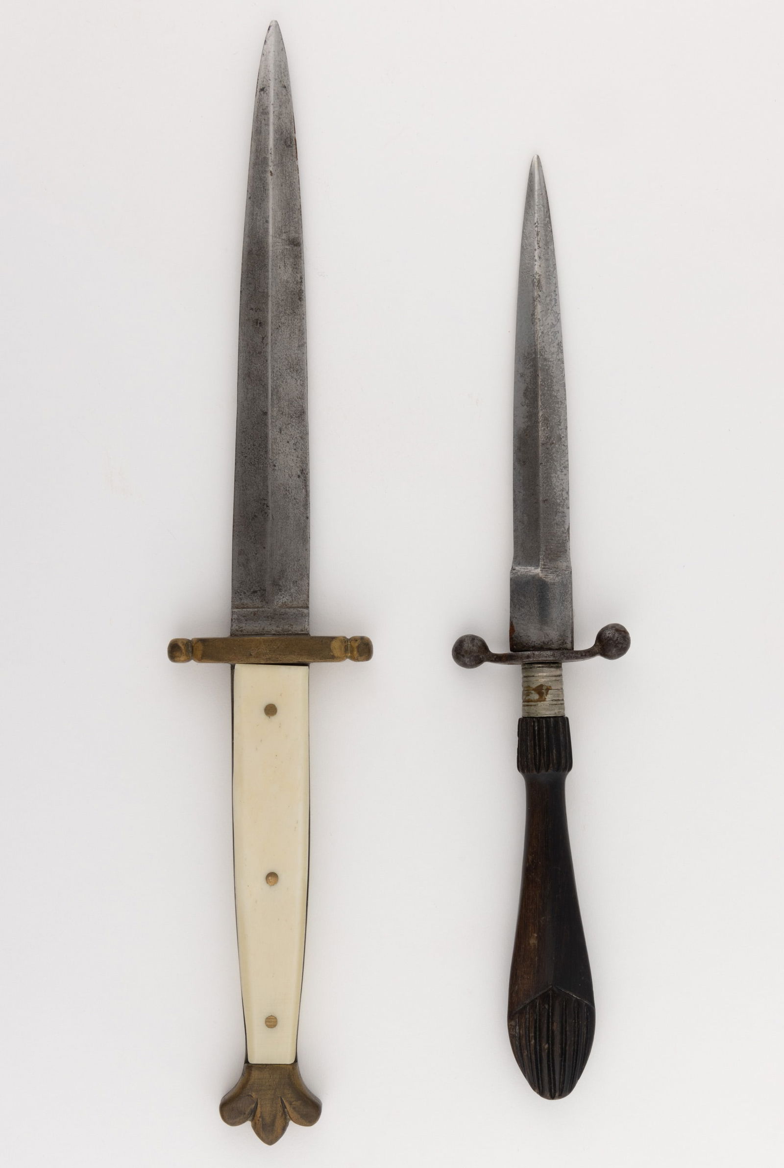 ANTIQUE SMALL DAGGERS / DIRKS, LOT OF TWO: ANTIQUE SMALL DAGGERS / DIRKS, LOT OF TWO, unmarked, one with a carved horn handle and a guard with ball-form terminals, and an example with bone grips and a brass pommel and guard. Second h