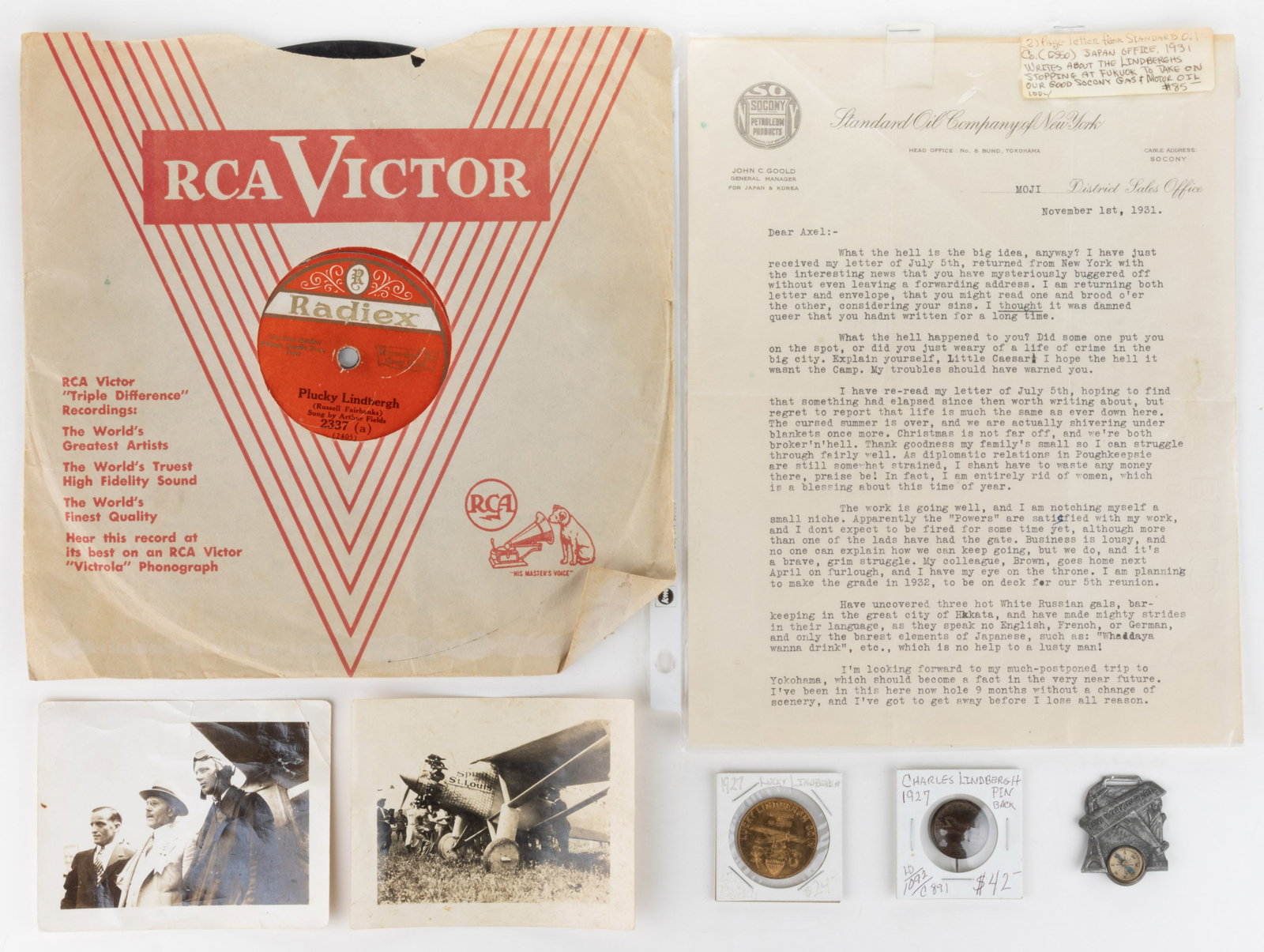 CHARLES LINDBERGH ARTICLES, LOT OF SEVEN: CHARLES LINDBERGH ARTICLES, LOT OF SEVEN, comprising two photographs; a "New York to Paris" watch fob with compass; a 1927 "Lucky Lindbergh Coin" token; a brass coat button with ad