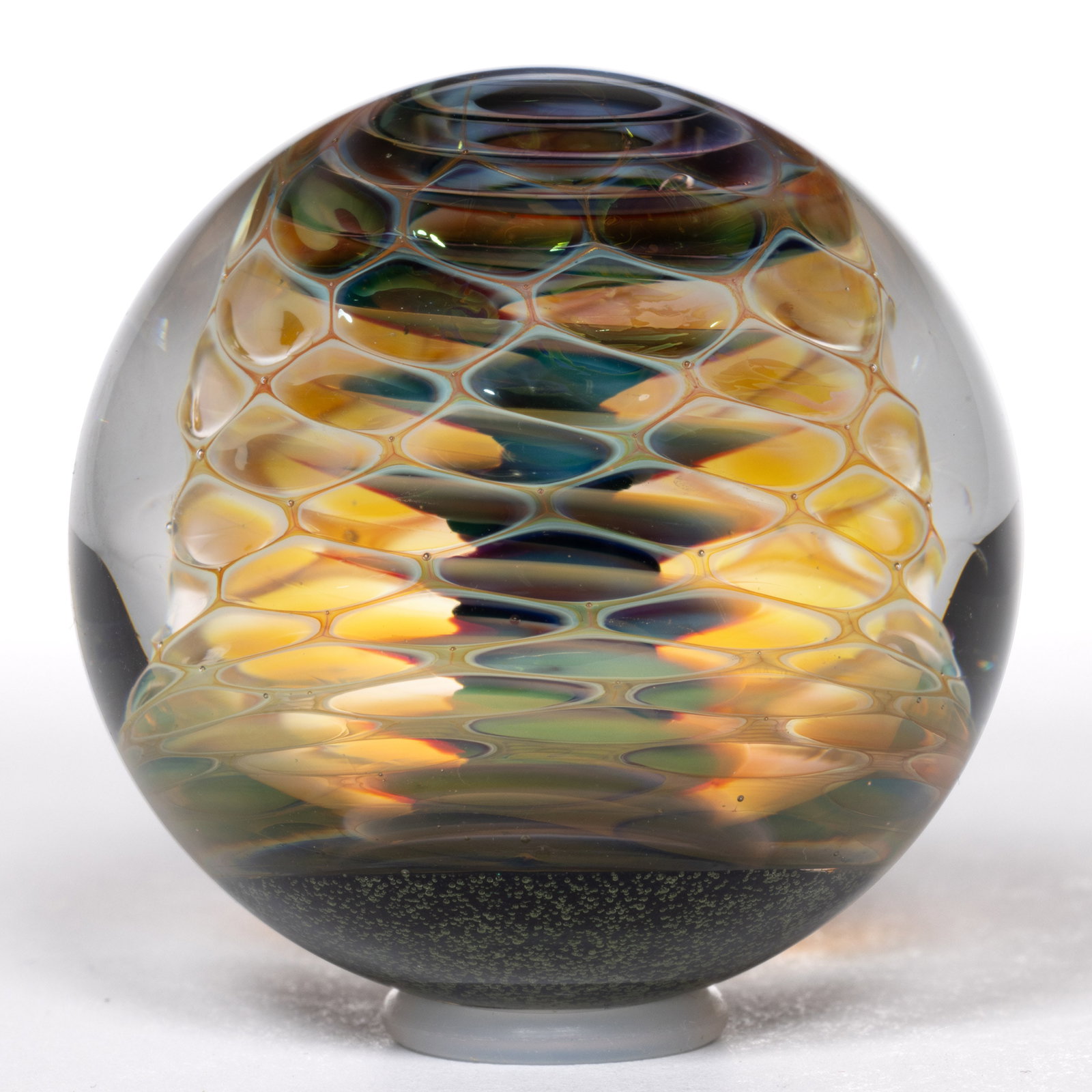 PHIL HACKMAN (AMERICAN, B. 1980) TRANSPARENT HONEYCOMB AND TWISTED CORE STUDIO ART GLASS MARBLE: PHIL HACKMAN (AMERICAN, B. 1980) TRANSPARENT HONEYCOMB AND TWISTED CORE STUDIO ART GLASS MARBLE, encased opalescent honeycomb which shows an interior multi-colored screw/twisted core, each terminating