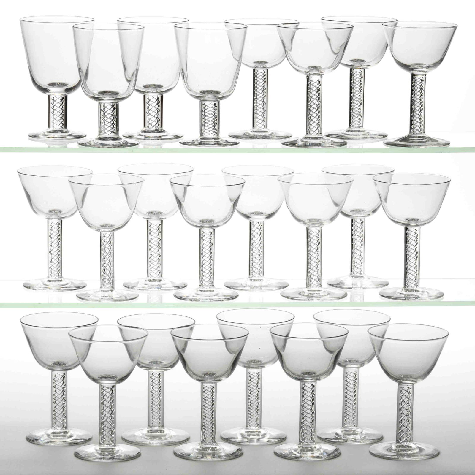 STEUBEN NO. 8011 CRYSTAL ART GLASS DRINKING ARTICLES, LOT OF 24: STEUBEN NO. 8011 CRYSTAL ART GLASS DRINKING ARTICLES, LOT OF 24, colorless, comprising four red wine glasses, and 20 cocktail glasses, each signed to the underside. Steuben Glass Works. 20th century.